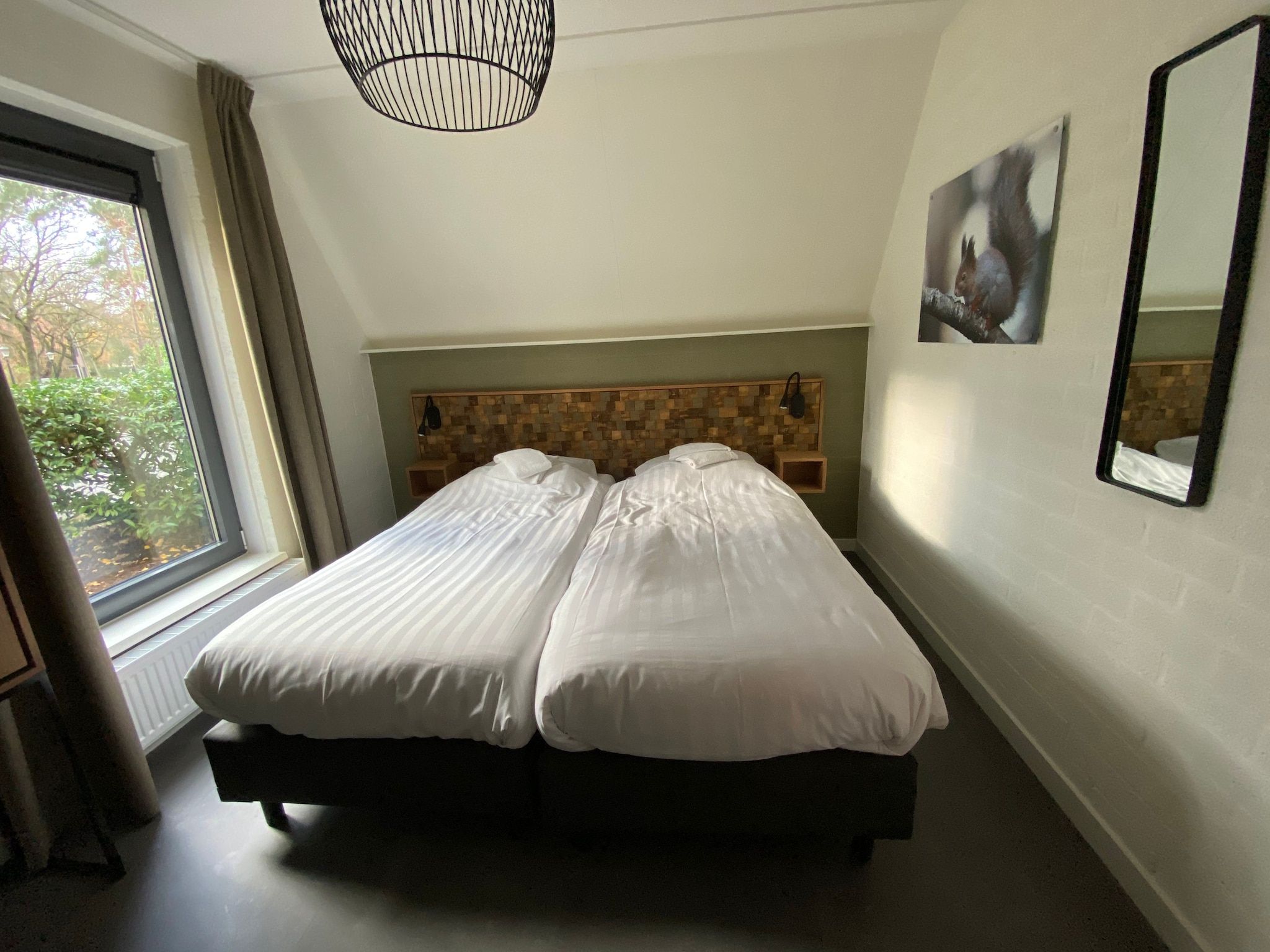 Een slaapkamer van Vakantiepark de Katjeskelder 21 in Oosterhout