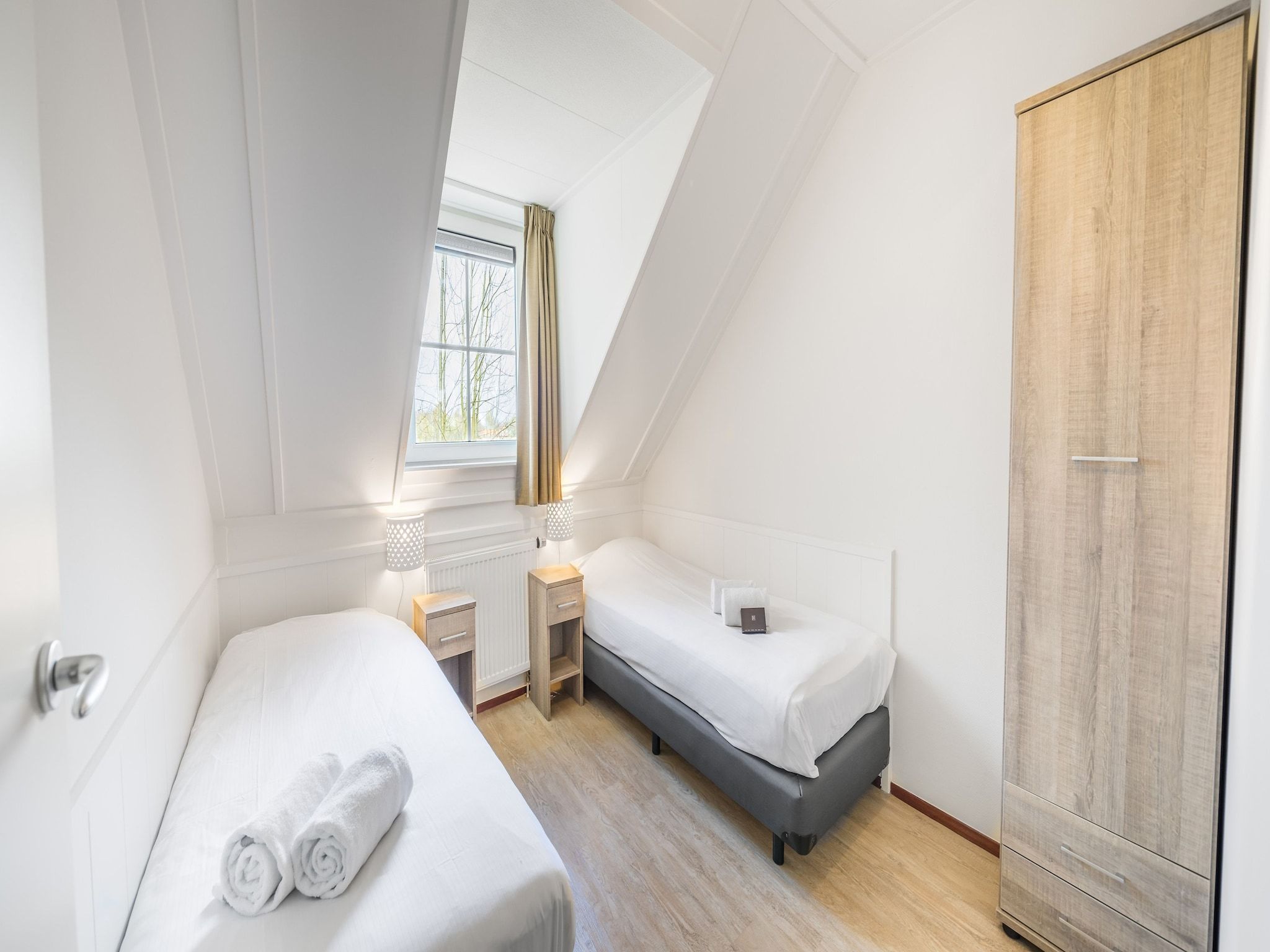 Een slaapkamer van Vakantiepark Weerterbergen 13 in Weert