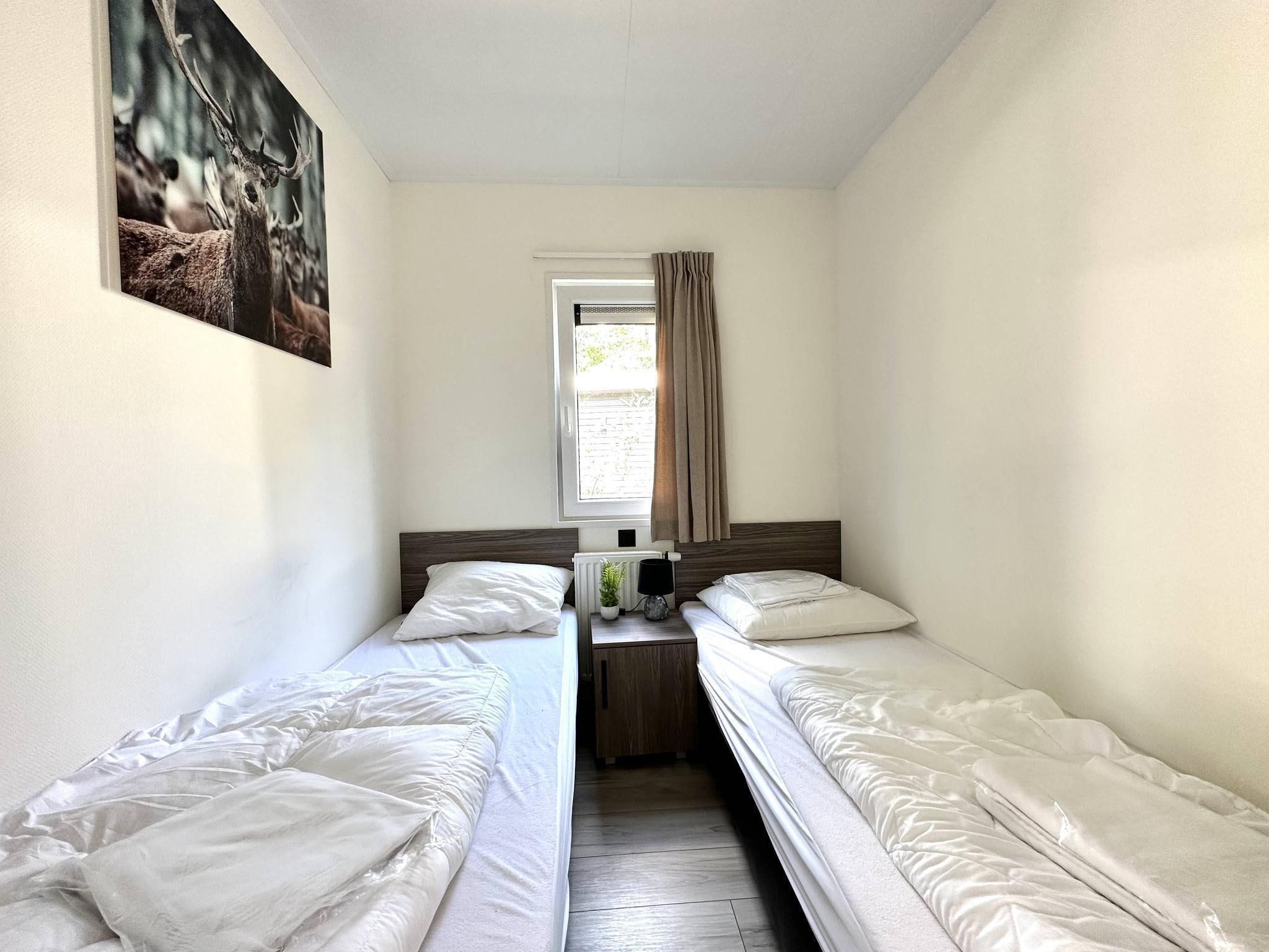 Een slaapkamer van Vakantiepark De Rimboe & De Woeste Hoogte 28 in Hoenderloo