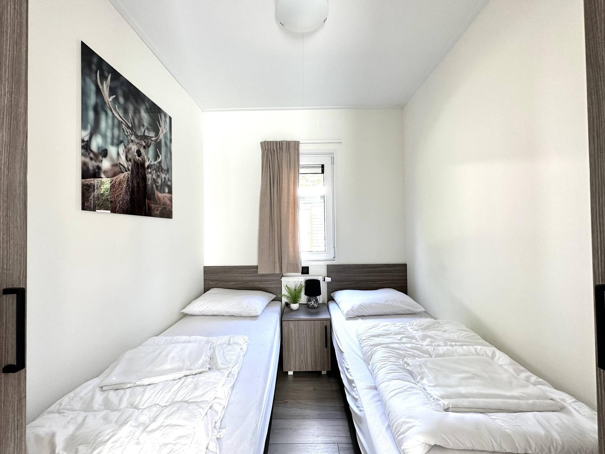 Een slaapkamer van Vakantiepark De Rimboe & De Woeste Hoogte 28 in Hoenderloo