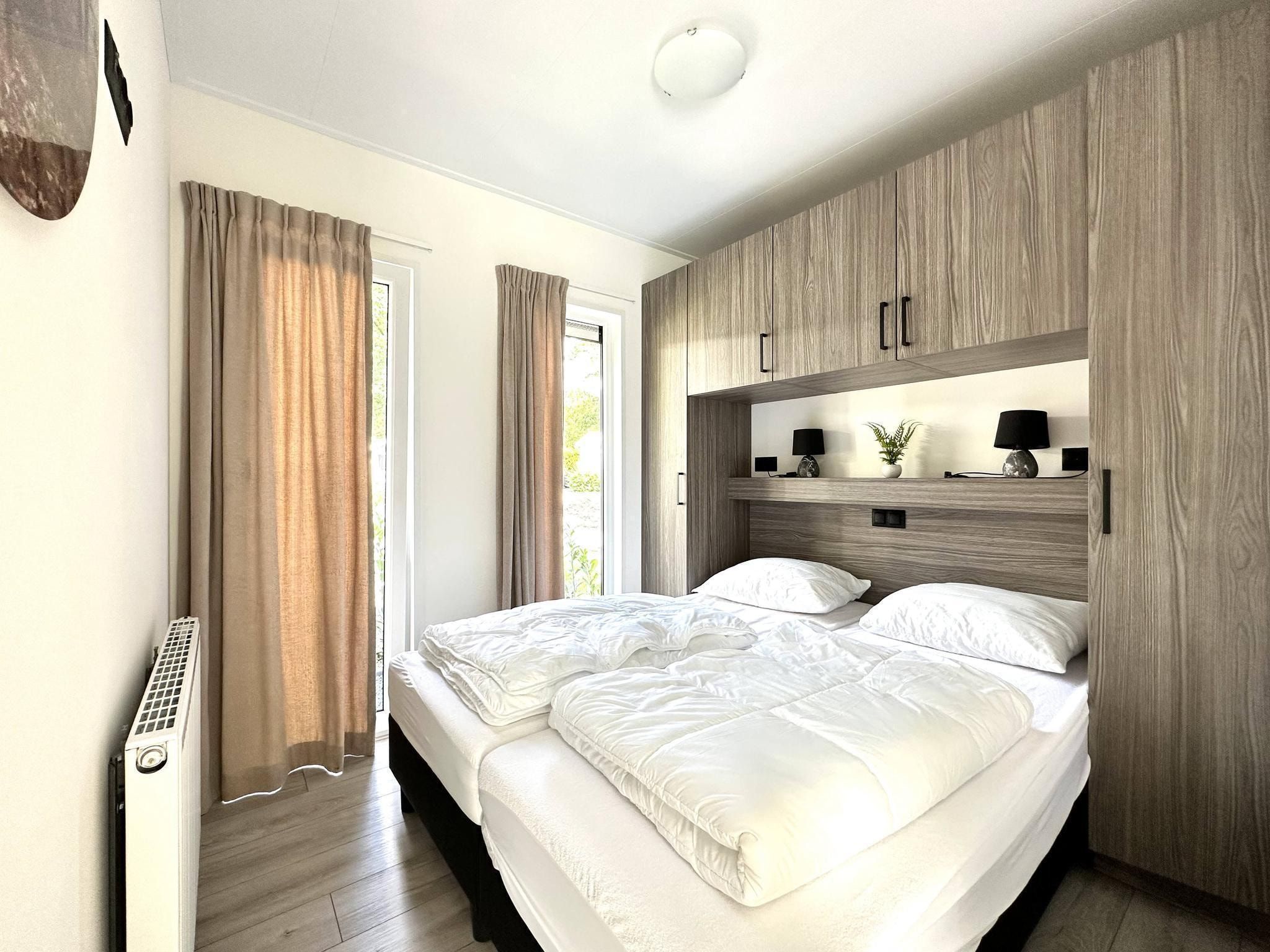 Een slaapkamer van Vakantiepark De Rimboe & De Woeste Hoogte 28 in Hoenderloo