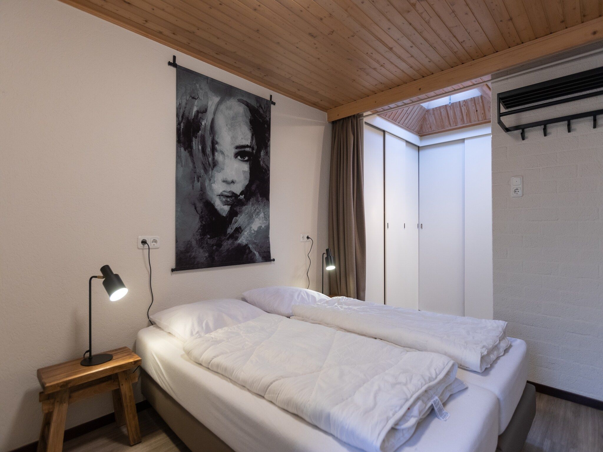 Een slaapkamer van Vakantie bij Meeussen - Schuttersoord 4 in Mook