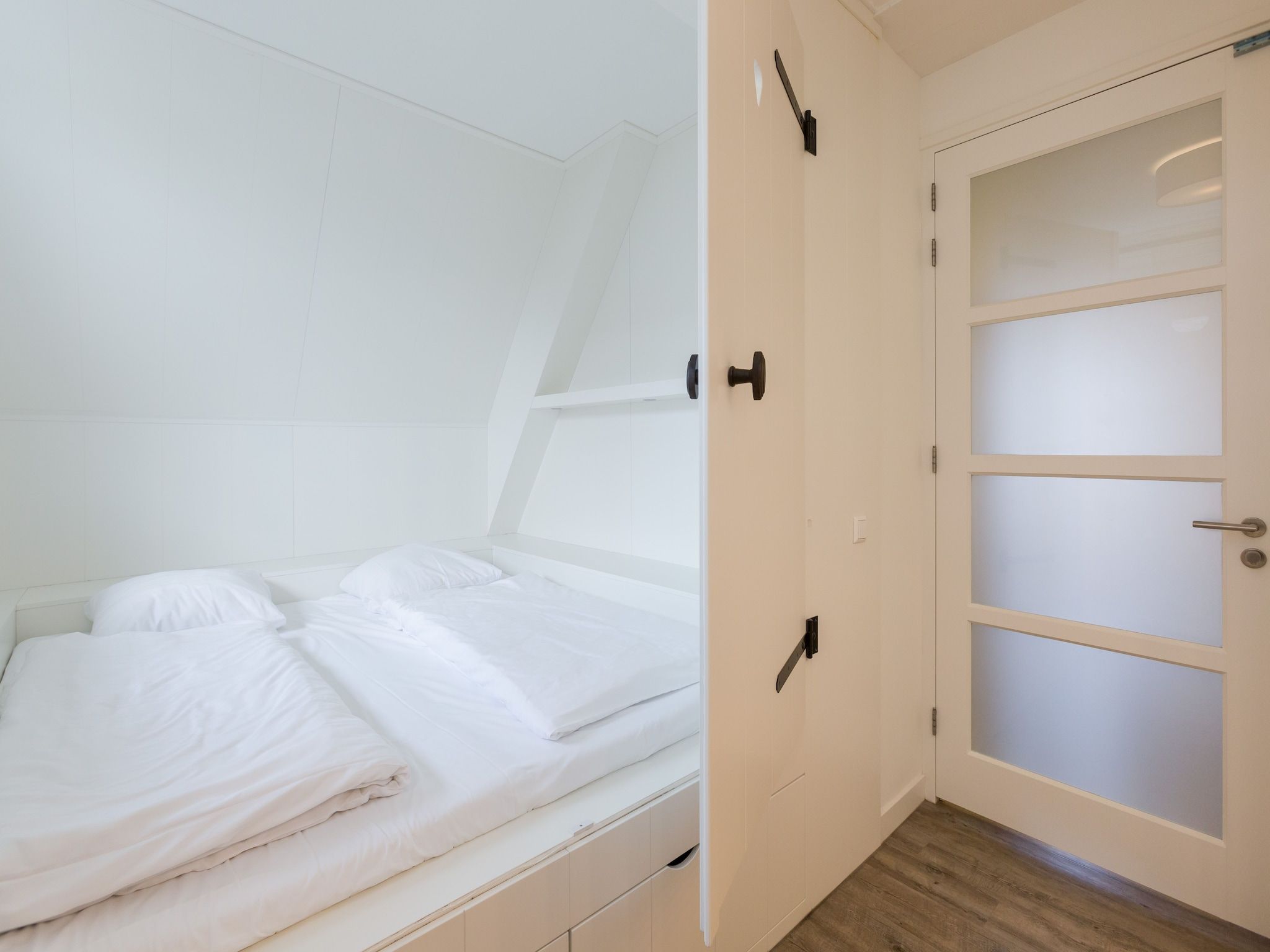 Een slaapkamer van Friese Meren Villa's 17 in Delfstrahuizen