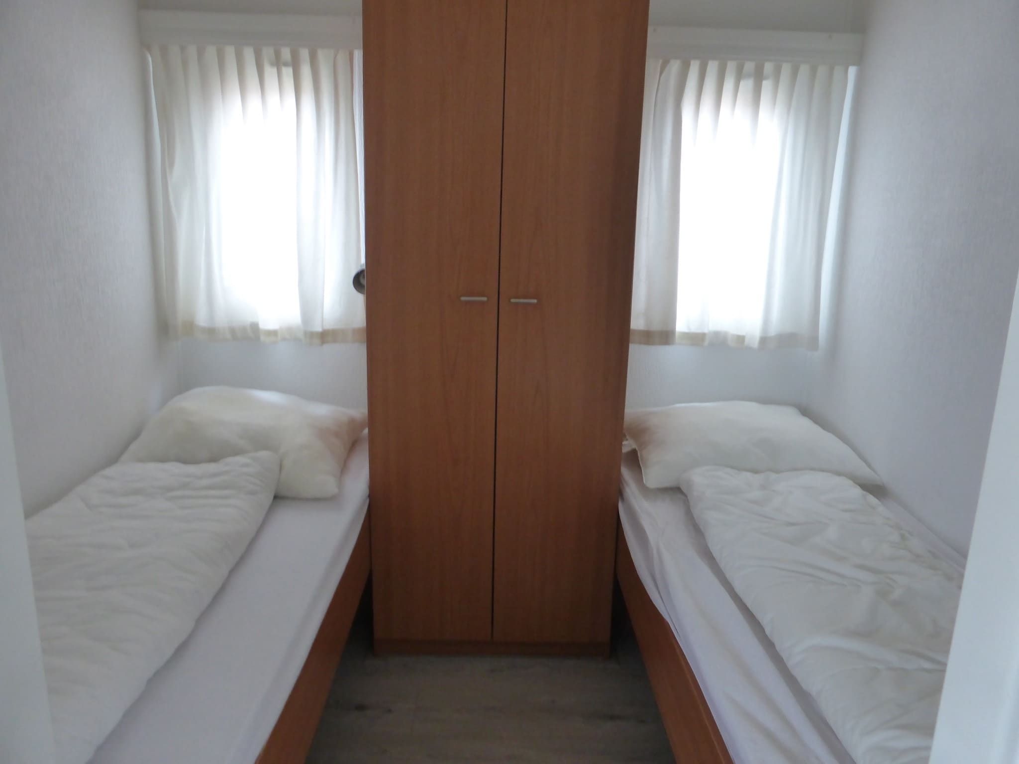 Een slaapkamer van Recreatiepark Rhederlaagse Meren 3 in Lathum