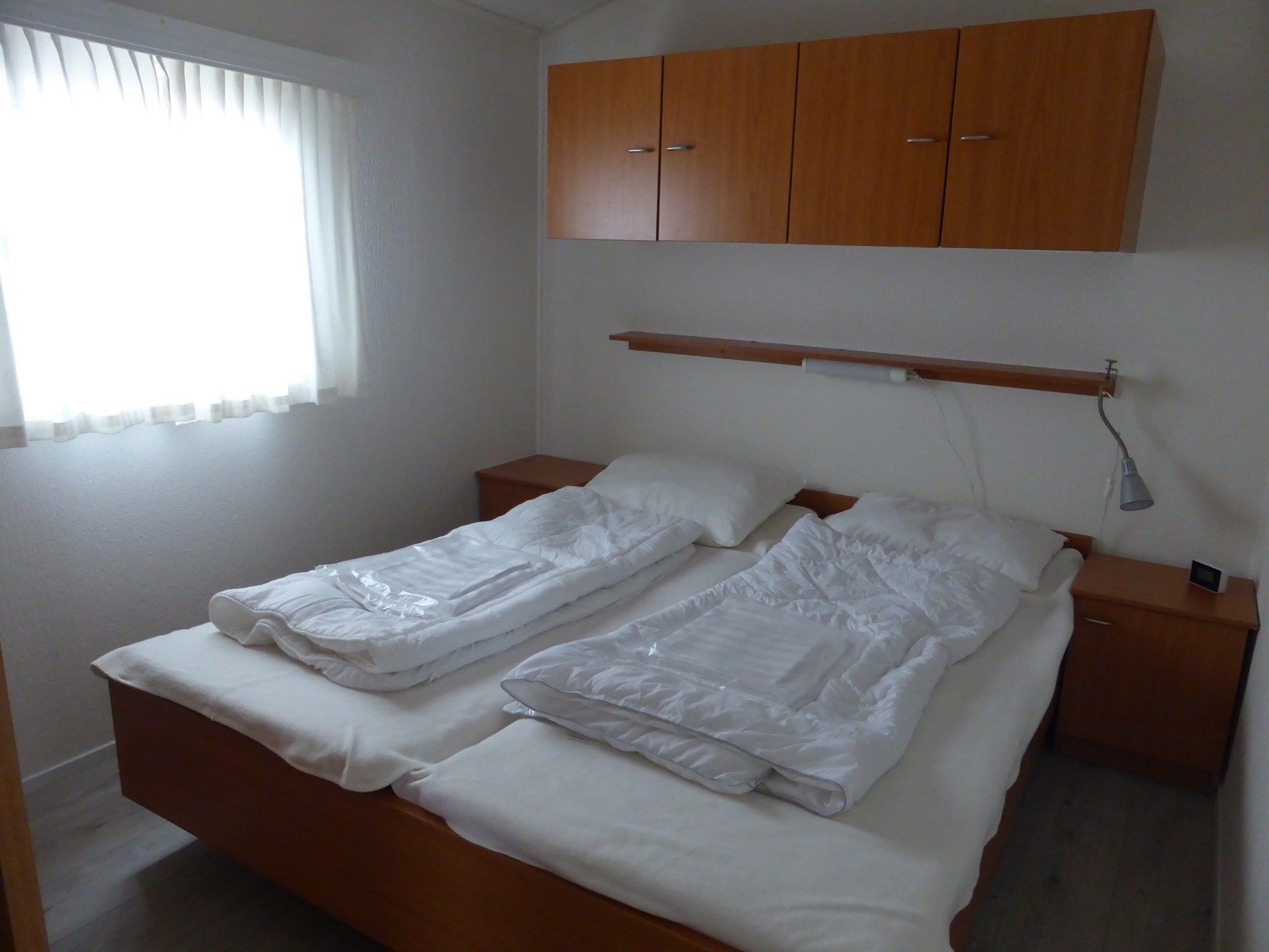 Een slaapkamer van Recreatiepark Rhederlaagse Meren 3 in Lathum