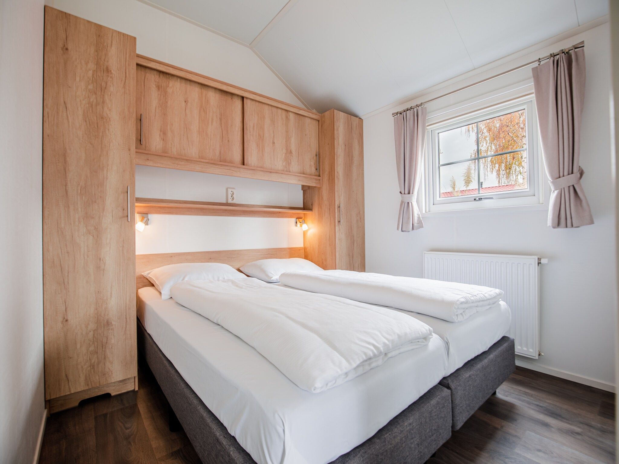 Een slaapkamer van Vakantiepark Leukermeer 11 in Well