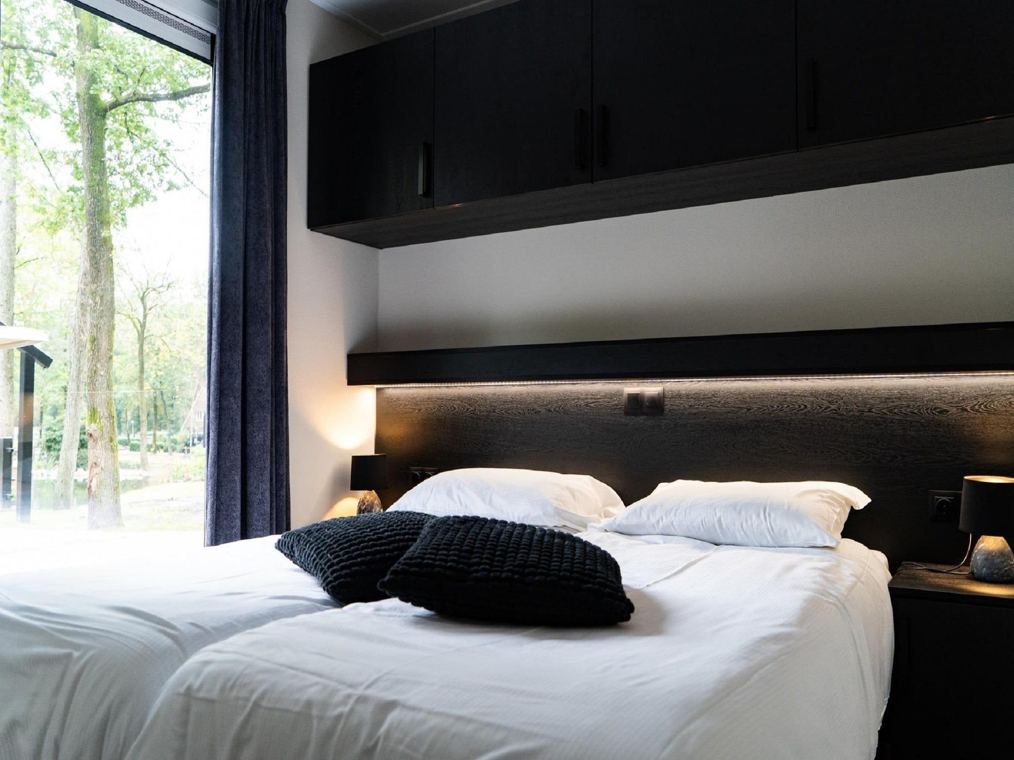 Een slaapkamer van Vakantiepark De Rimboe & De Woeste Hoogte 39 in Hoenderloo