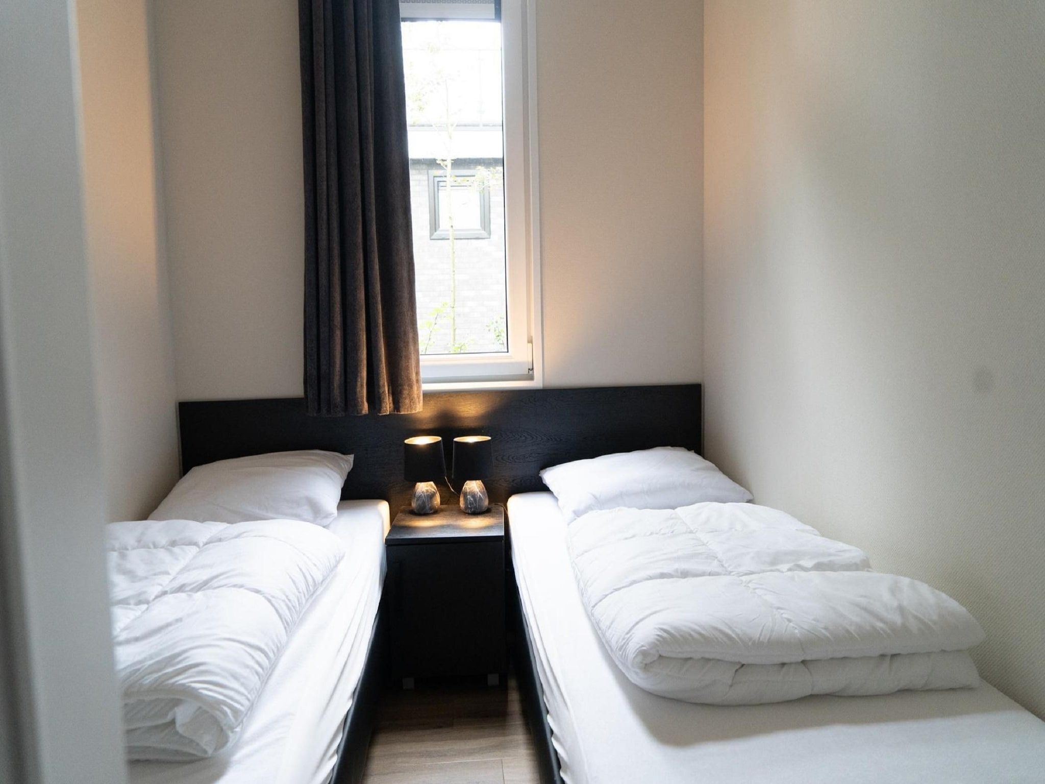 Een slaapkamer van Vakantiepark De Rimboe & De Woeste Hoogte 39 in Hoenderloo