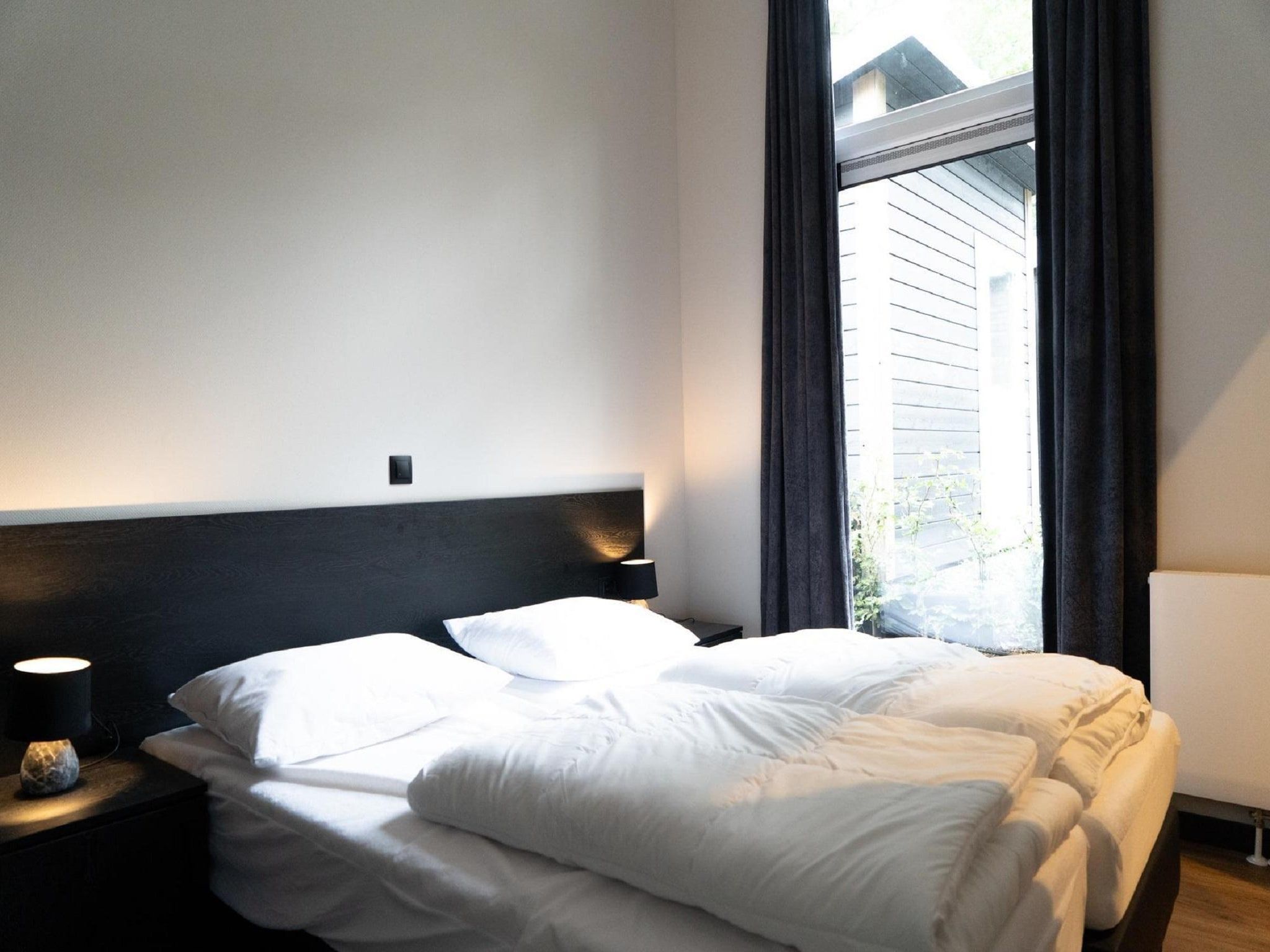 Een slaapkamer van Vakantiepark De Rimboe & De Woeste Hoogte 39 in Hoenderloo