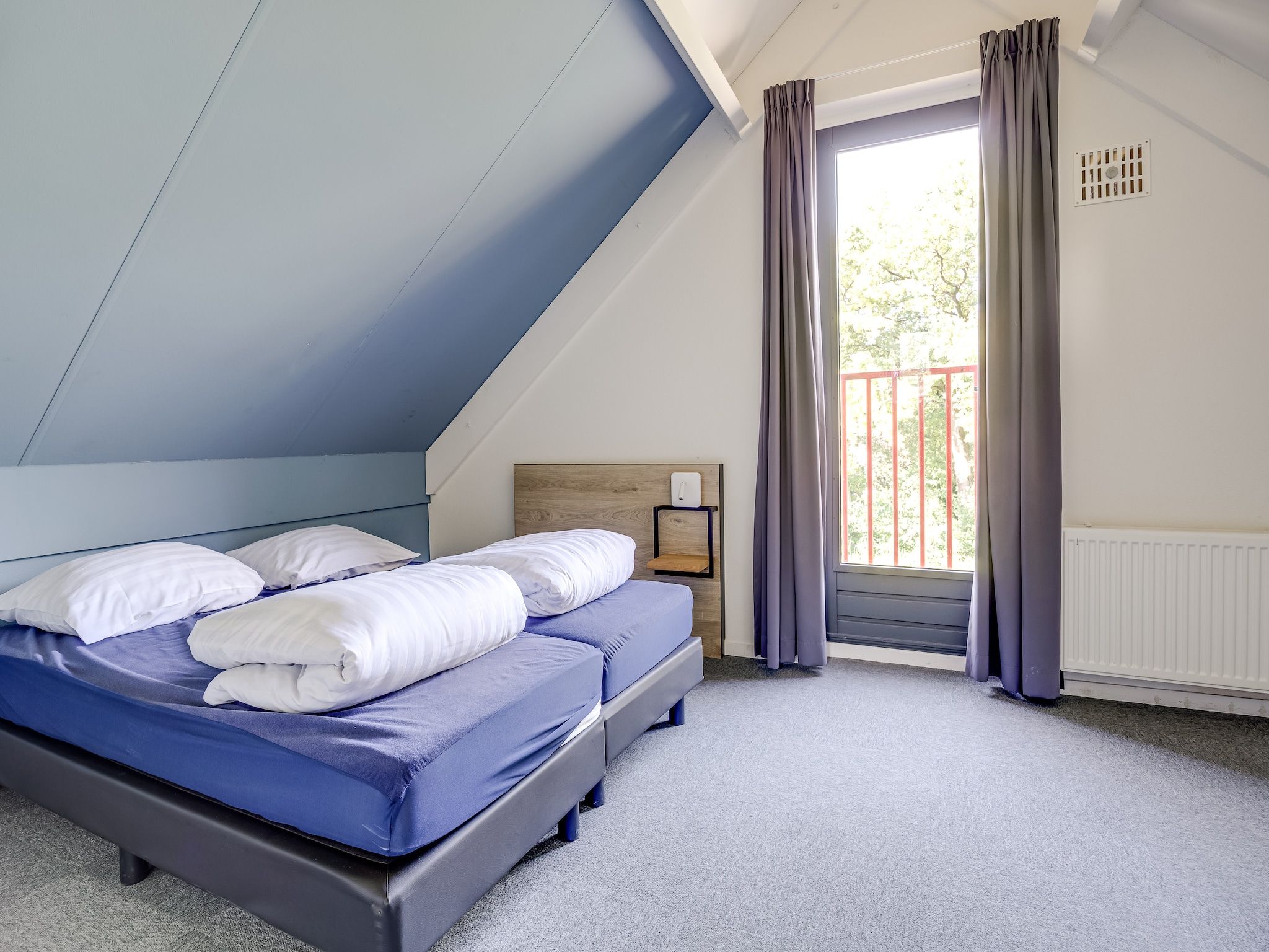 Een slaapkamer van Vakantiepark 't Broeckhuys 1 in Ewijk