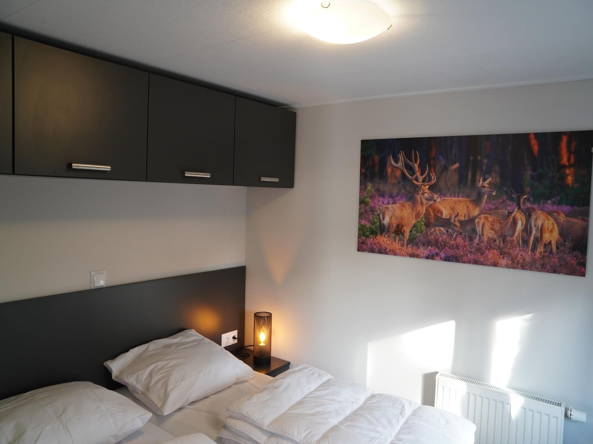 Een slaapkamer van Vakantiepark De Rimboe & De Woeste Hoogte 41 in Hoenderloo