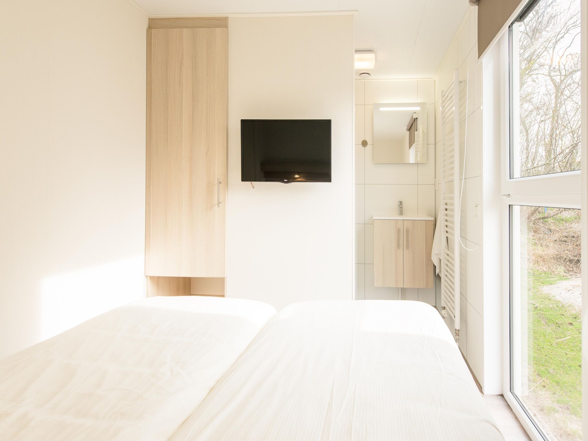 Een slaapkamer van Vakantiepark Boomhiemke 19 in Hollum