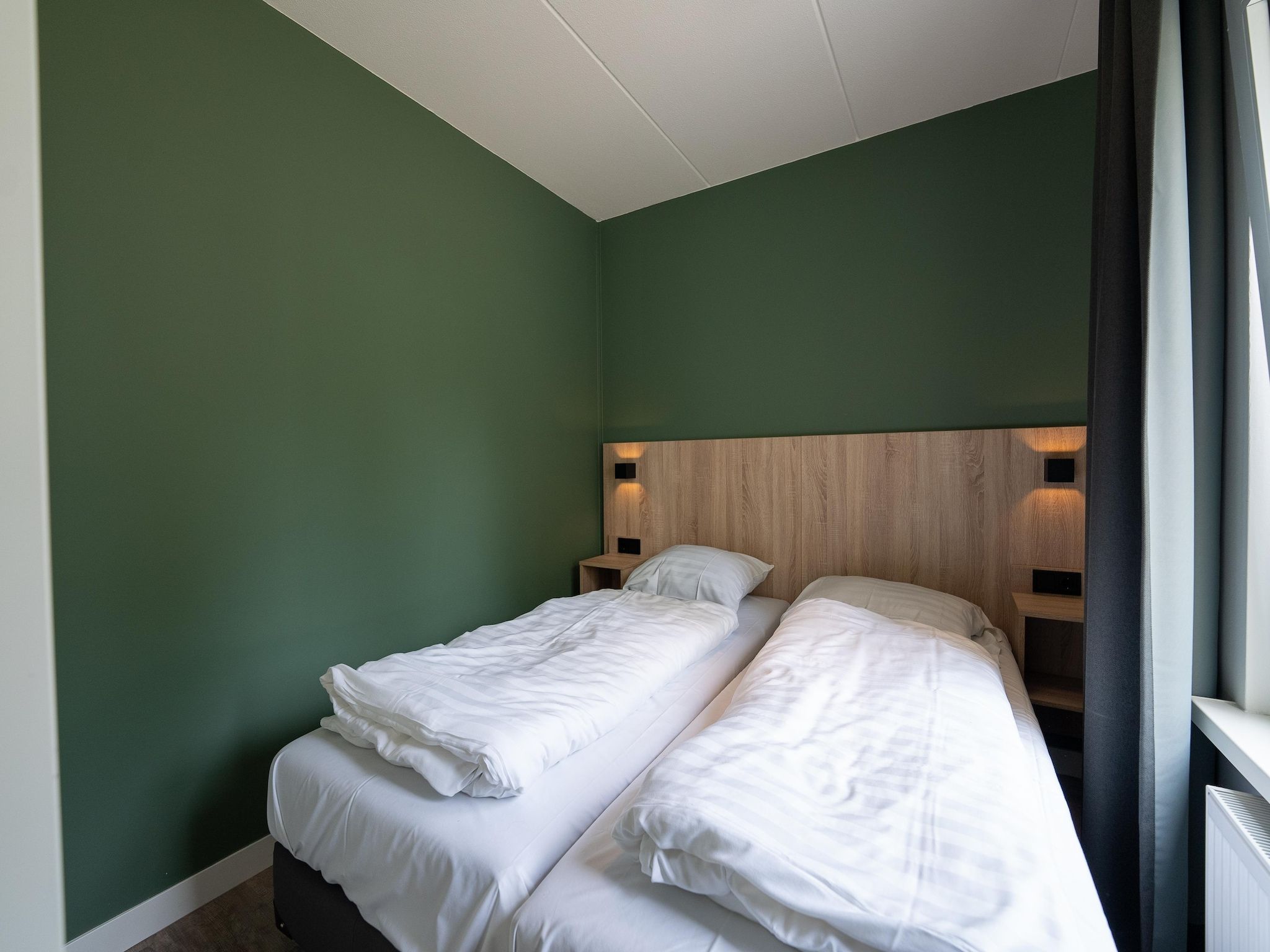 Een slaapkamer van Vakantiepark Hunzedal 18 in Borger