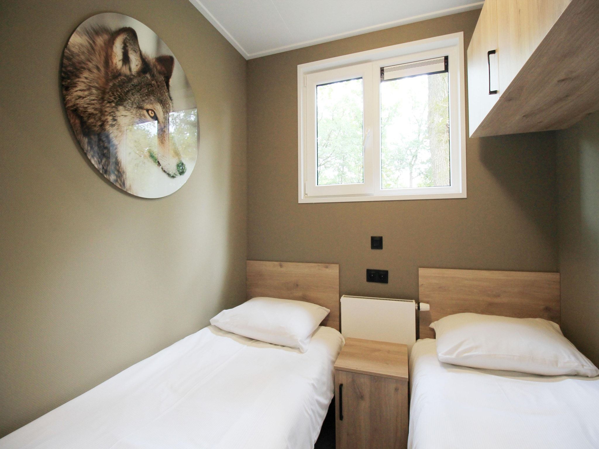 Een slaapkamer van Vakantiepark De Rimboe & De Woeste Hoogte 42 in Hoenderloo