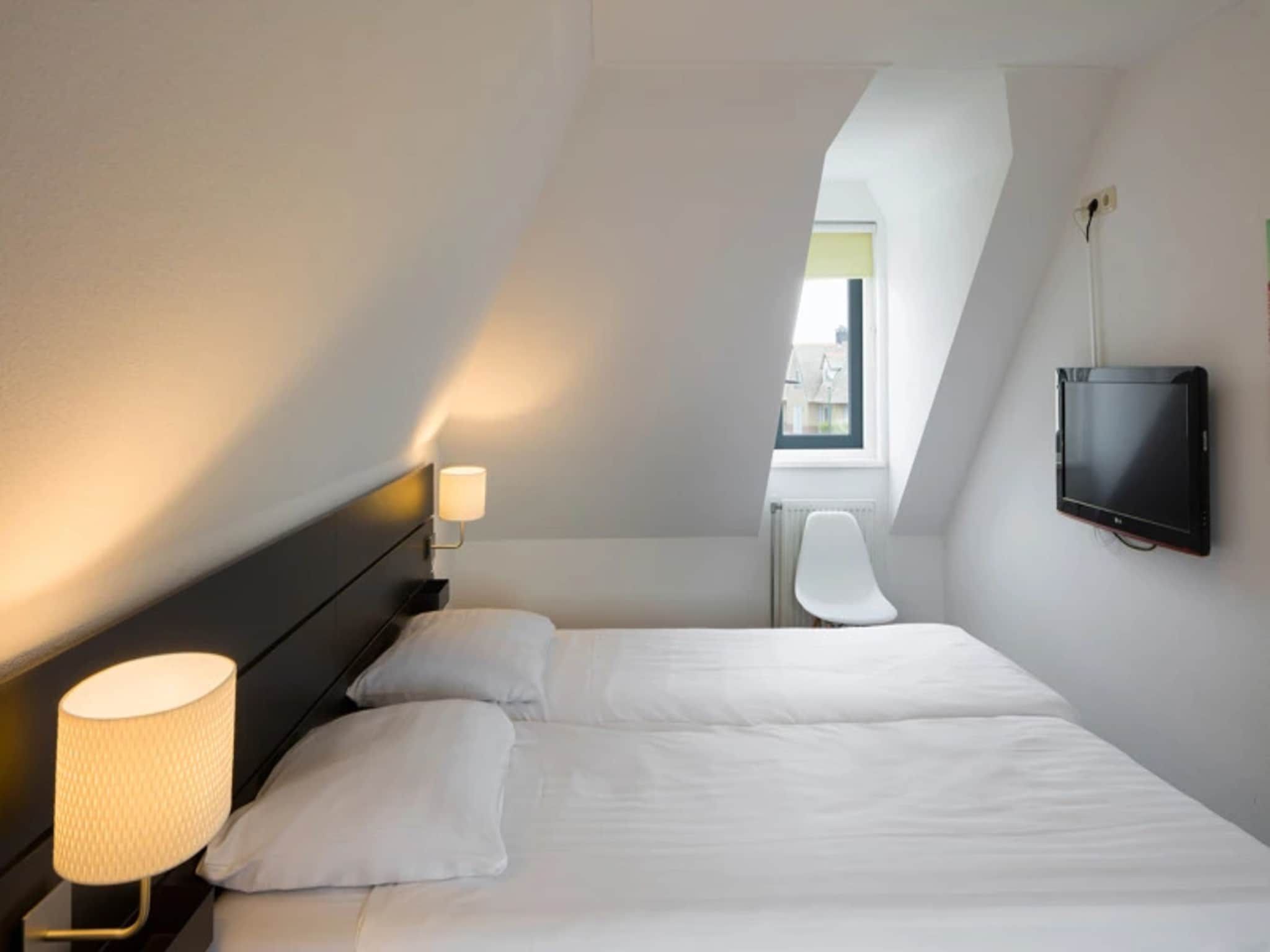 Een slaapkamer van Vakantiepark Duynzicht 2 in Julianadorp aan zee