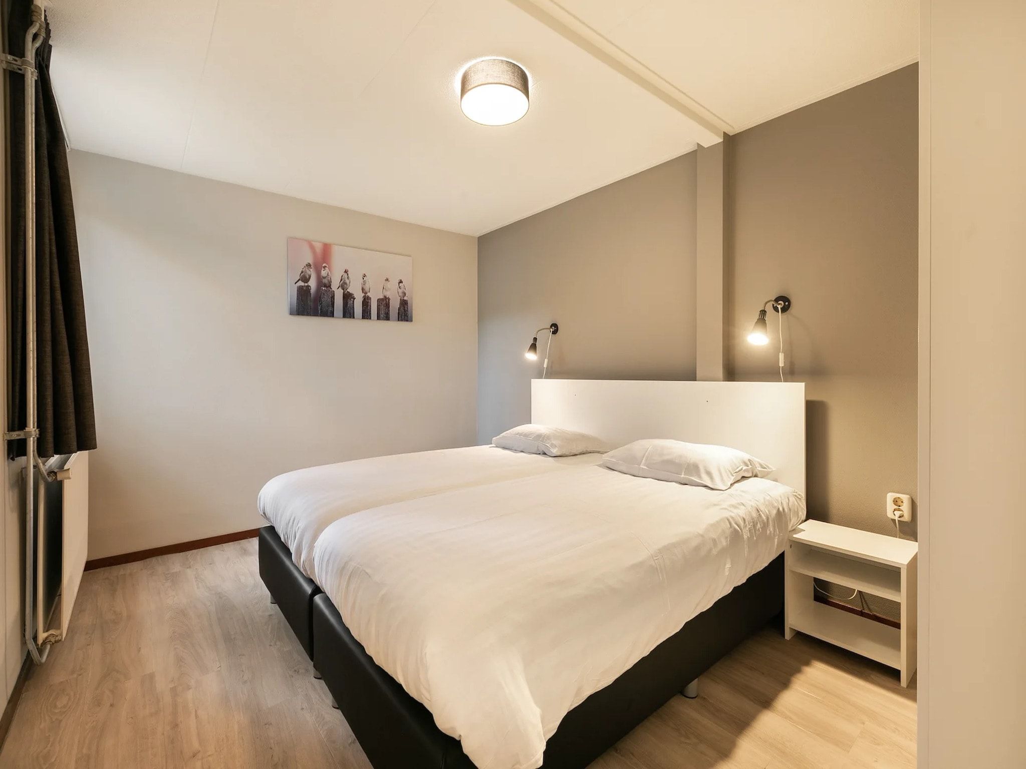 Een slaapkamer van Vakantiepark de Berkenhorst 14 in Kootwijk