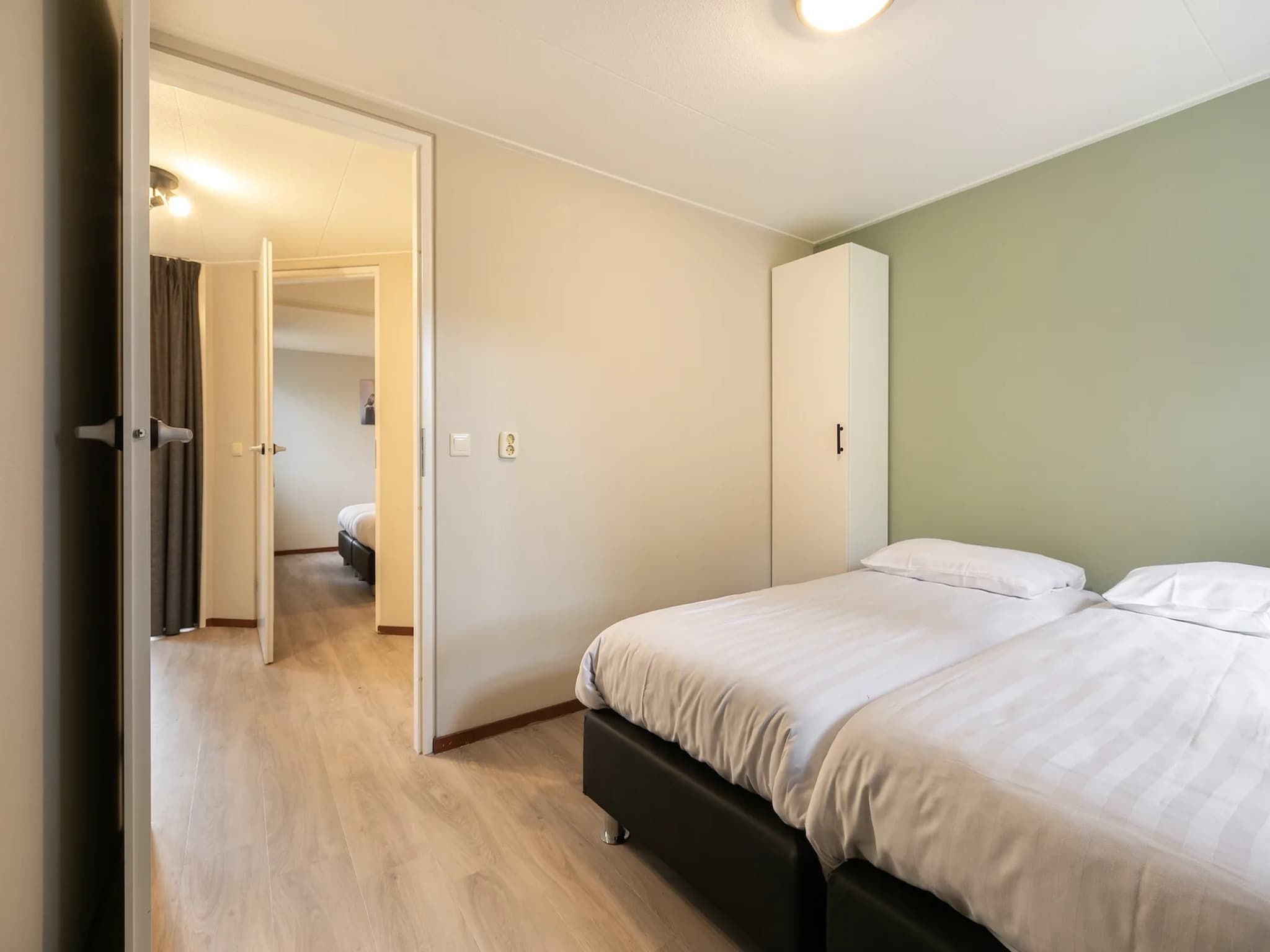 Een slaapkamer van Vakantiepark de Berkenhorst 14 in Kootwijk