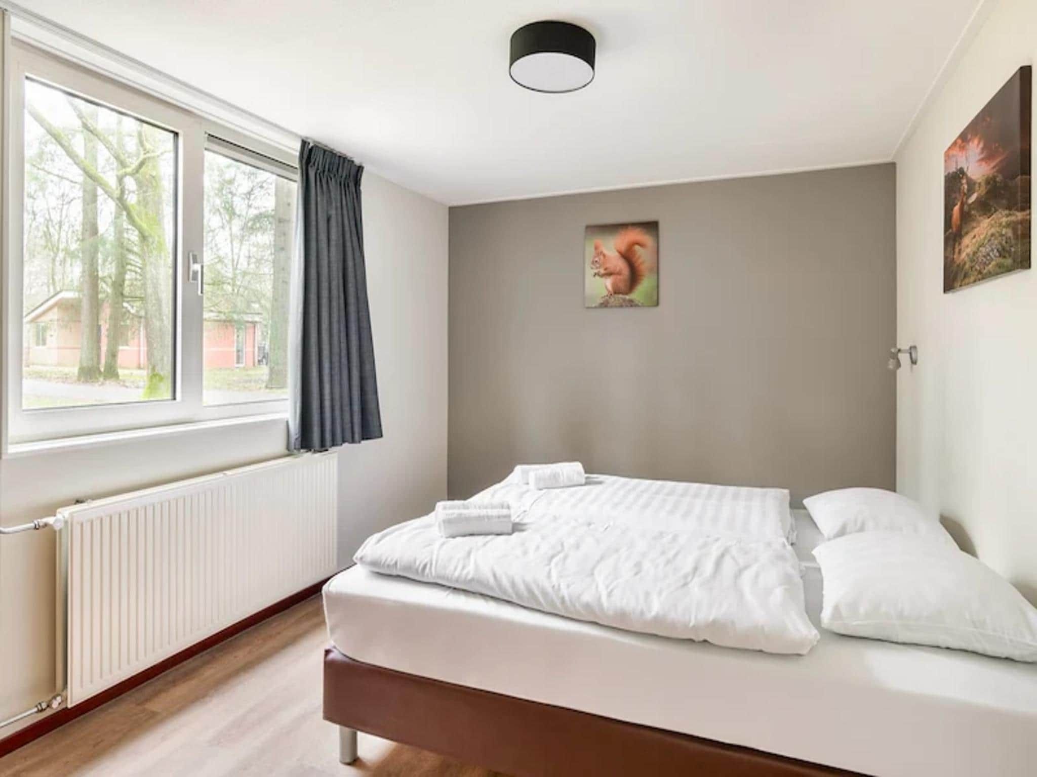 Een slaapkamer van Vakantiepark de Berkenhorst 17 in Kootwijk