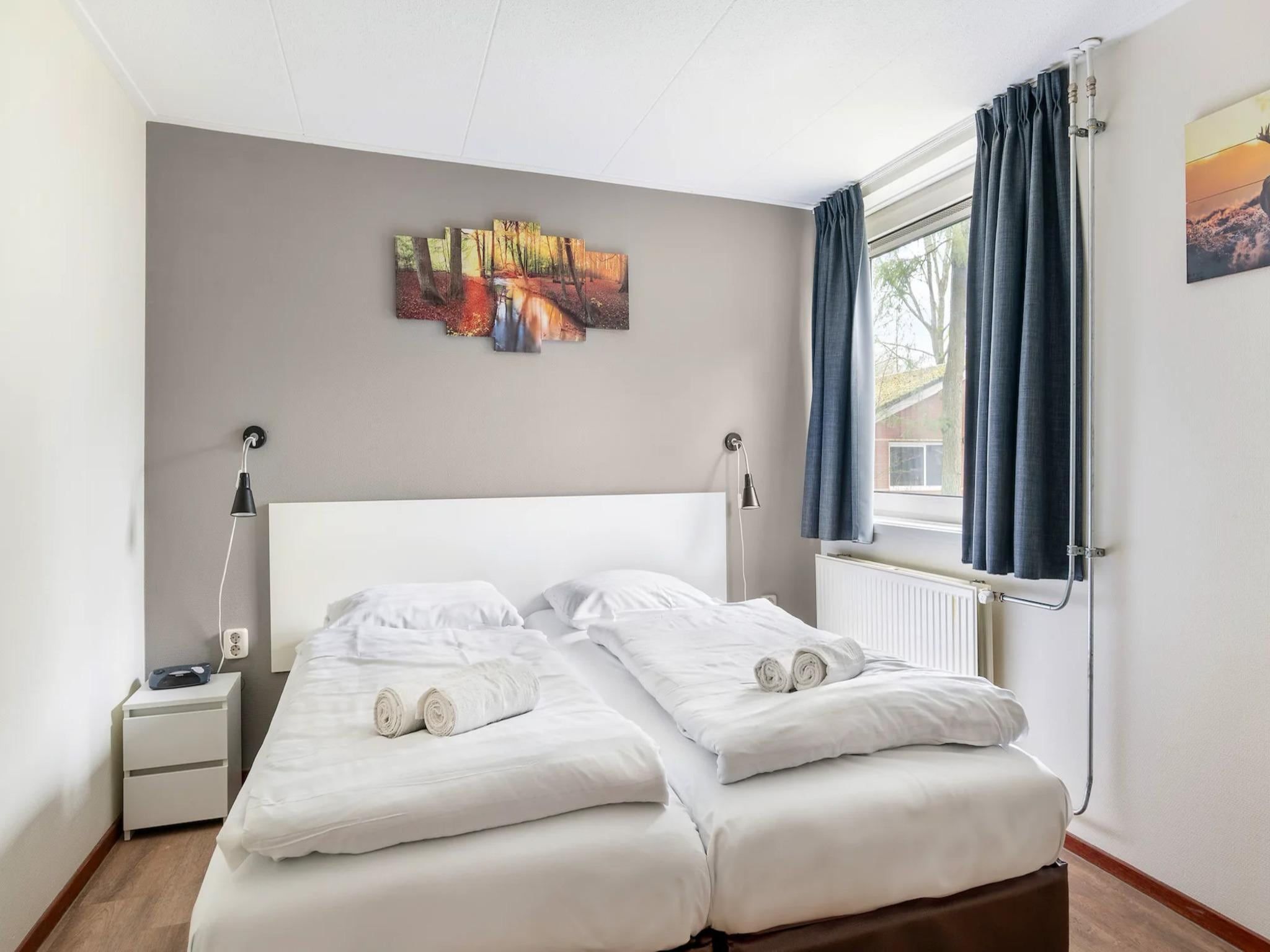 Een slaapkamer van Vakantiepark de Berkenhorst 19 in Kootwijk