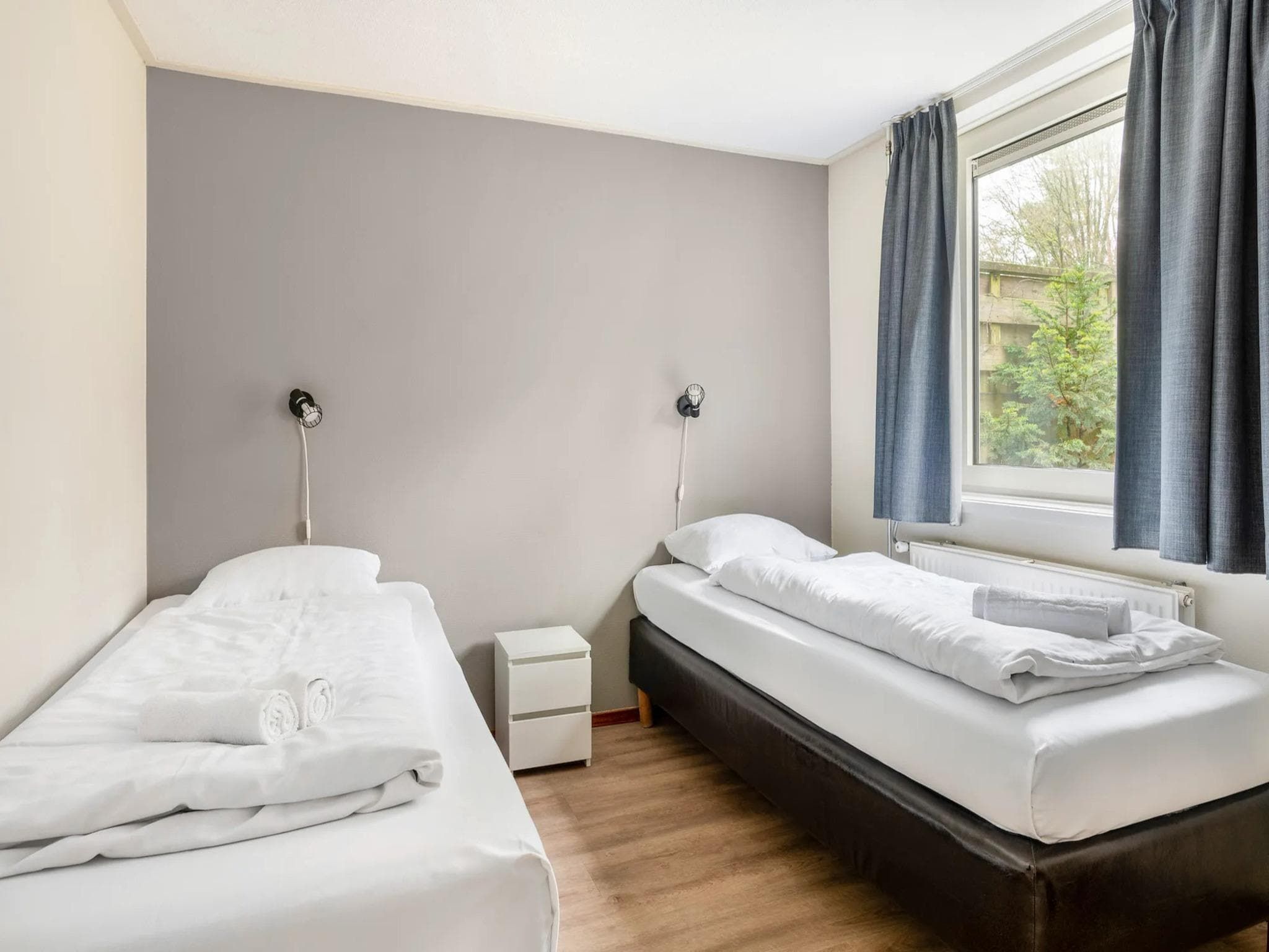 Een slaapkamer van Vakantiepark de Berkenhorst 19 in Kootwijk