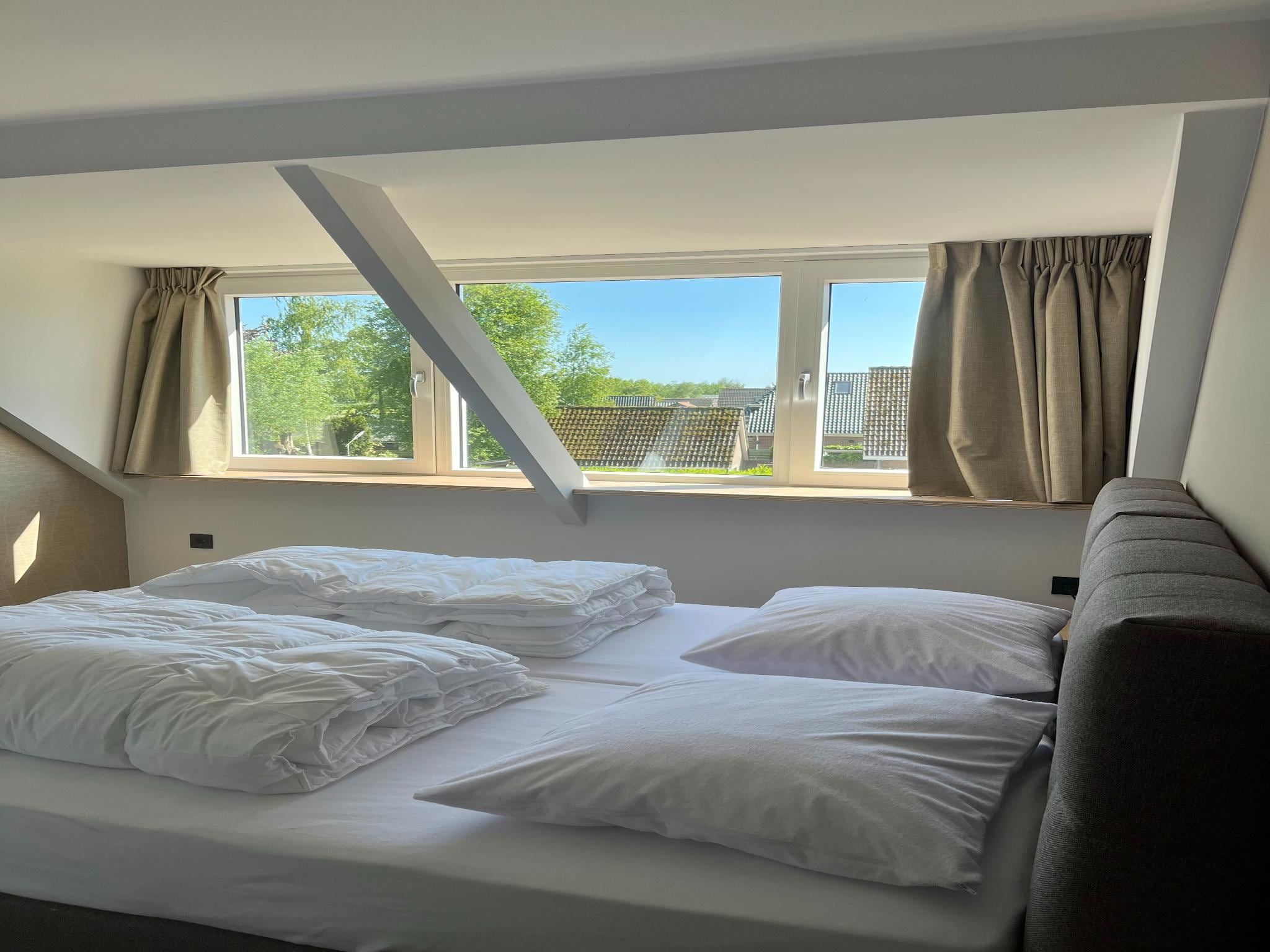 Een slaapkamer van Groepsaccommodatie + 4 large greenhouses (36 personen) in Scherpenzeel (FR)