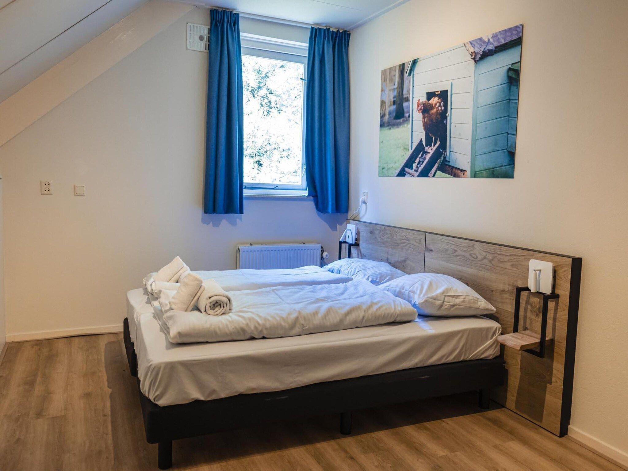 Een slaapkamer van 12 - Persons Family Bungalow in Ewijk