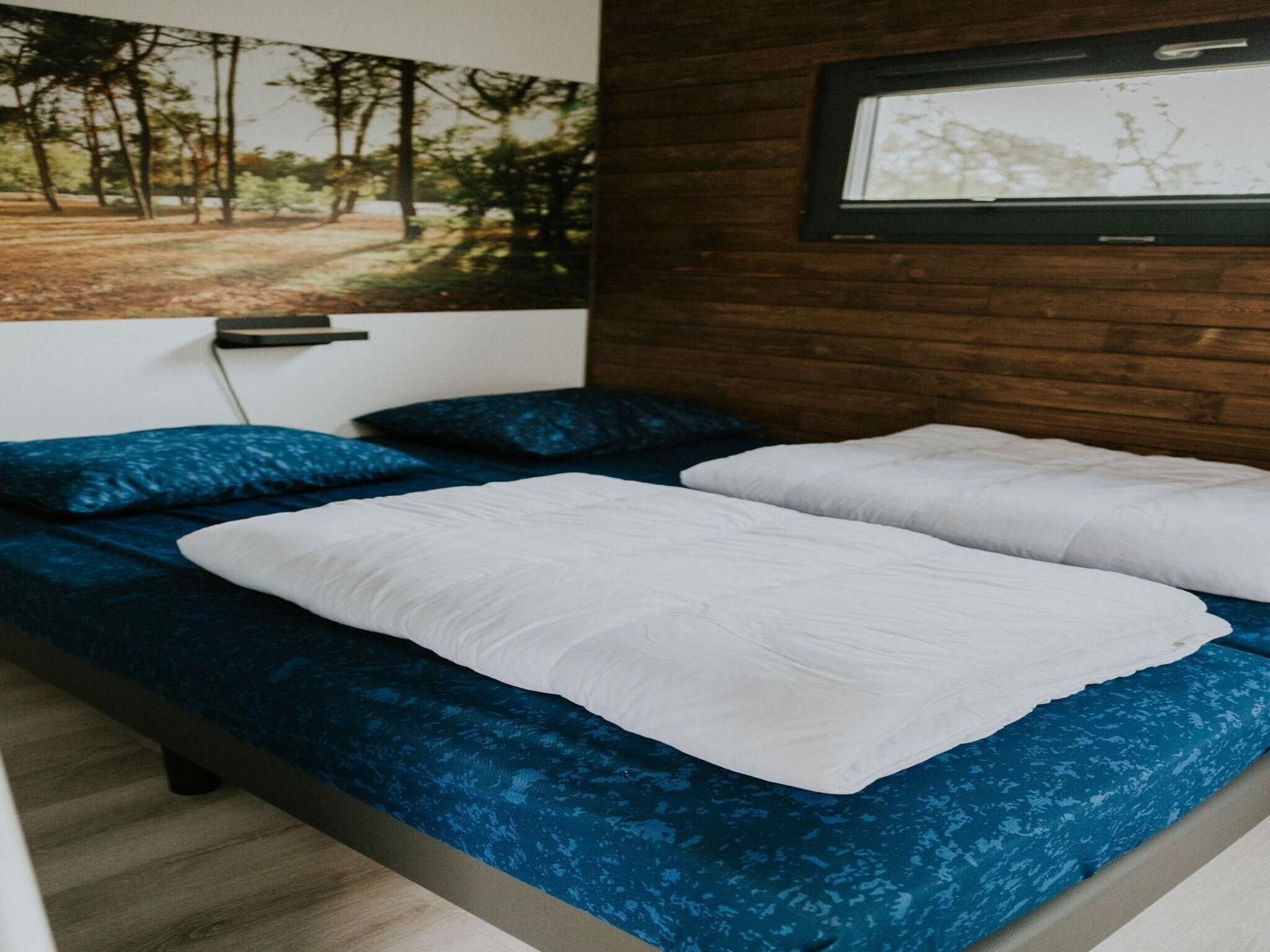 Een slaapkamer van Tiny house XL | 2-4 persoons in Balkbrug