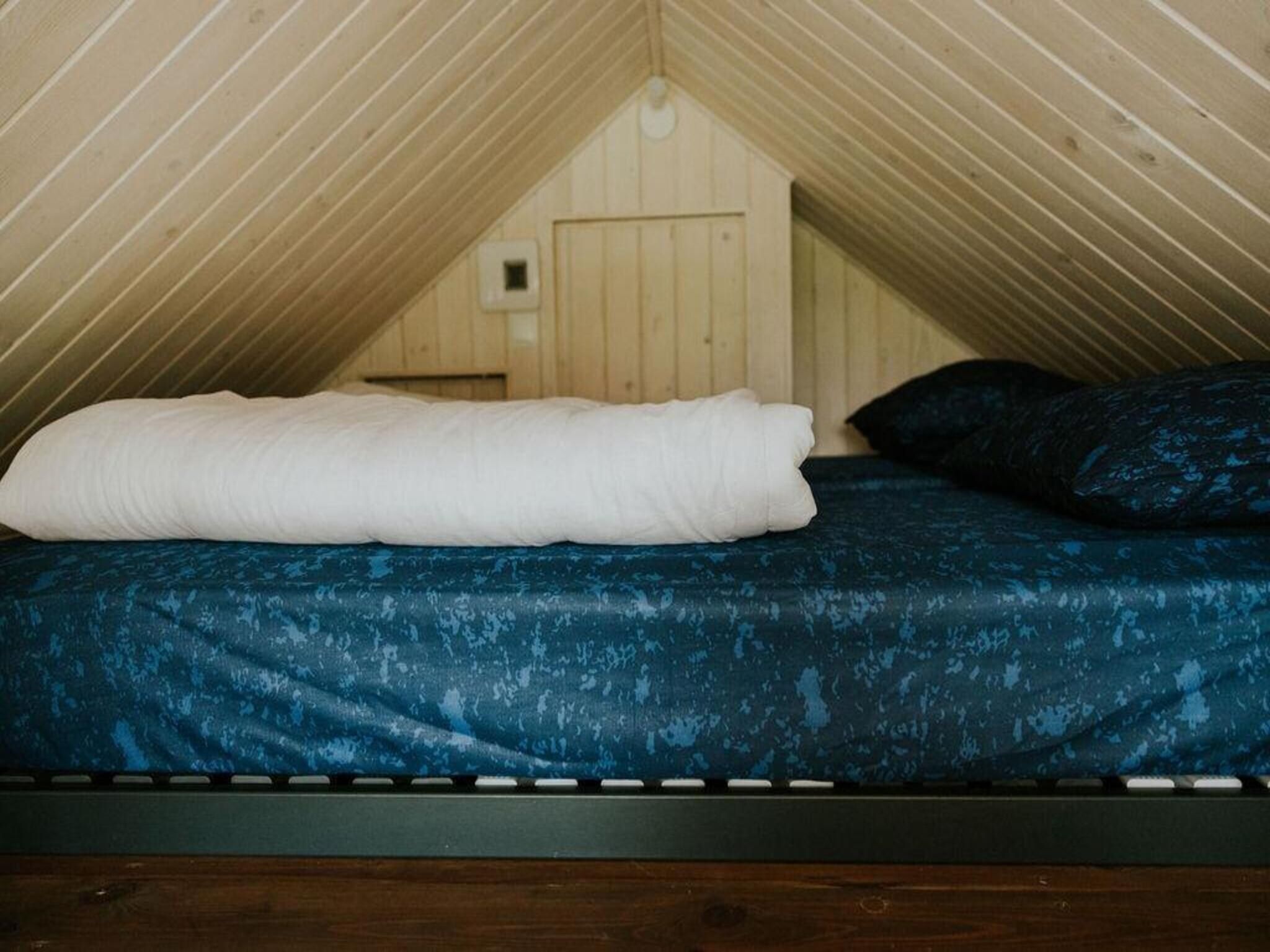 Een slaapkamer van Tiny house XL | 2-4 persoons in Balkbrug