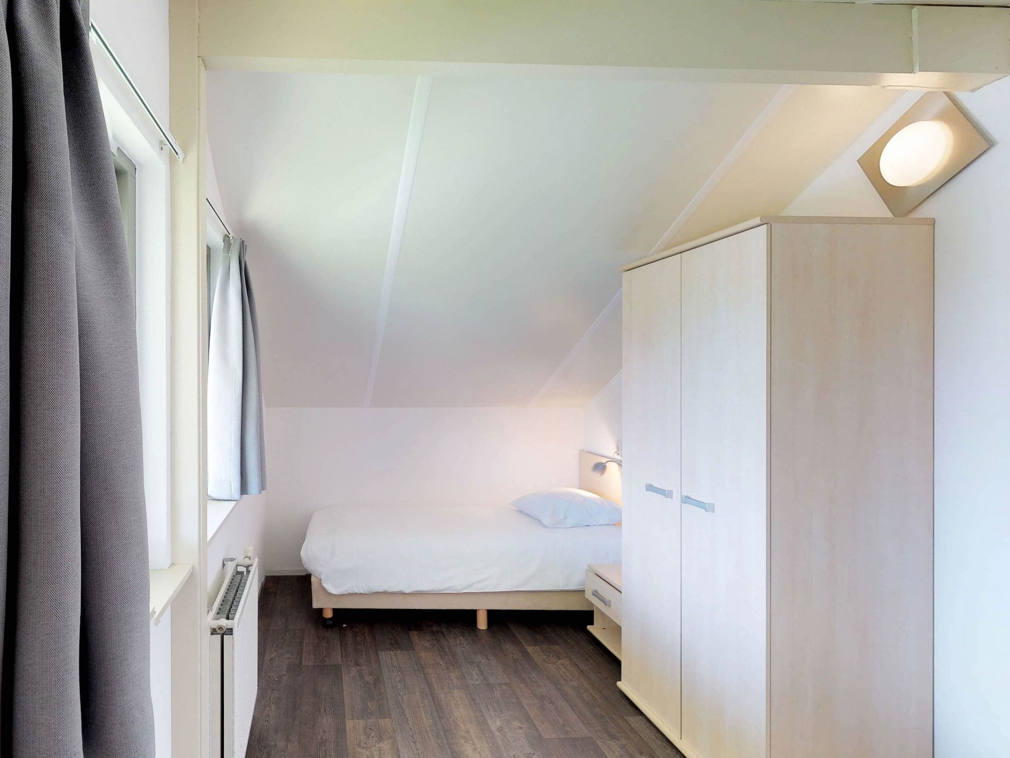 Een slaapkamer van Villapark de Paardekreek 3 in Kortgene