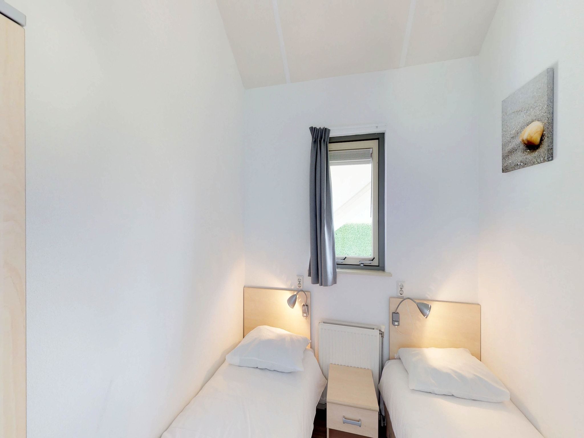 Een slaapkamer van Villapark de Paardekreek 3 in Kortgene