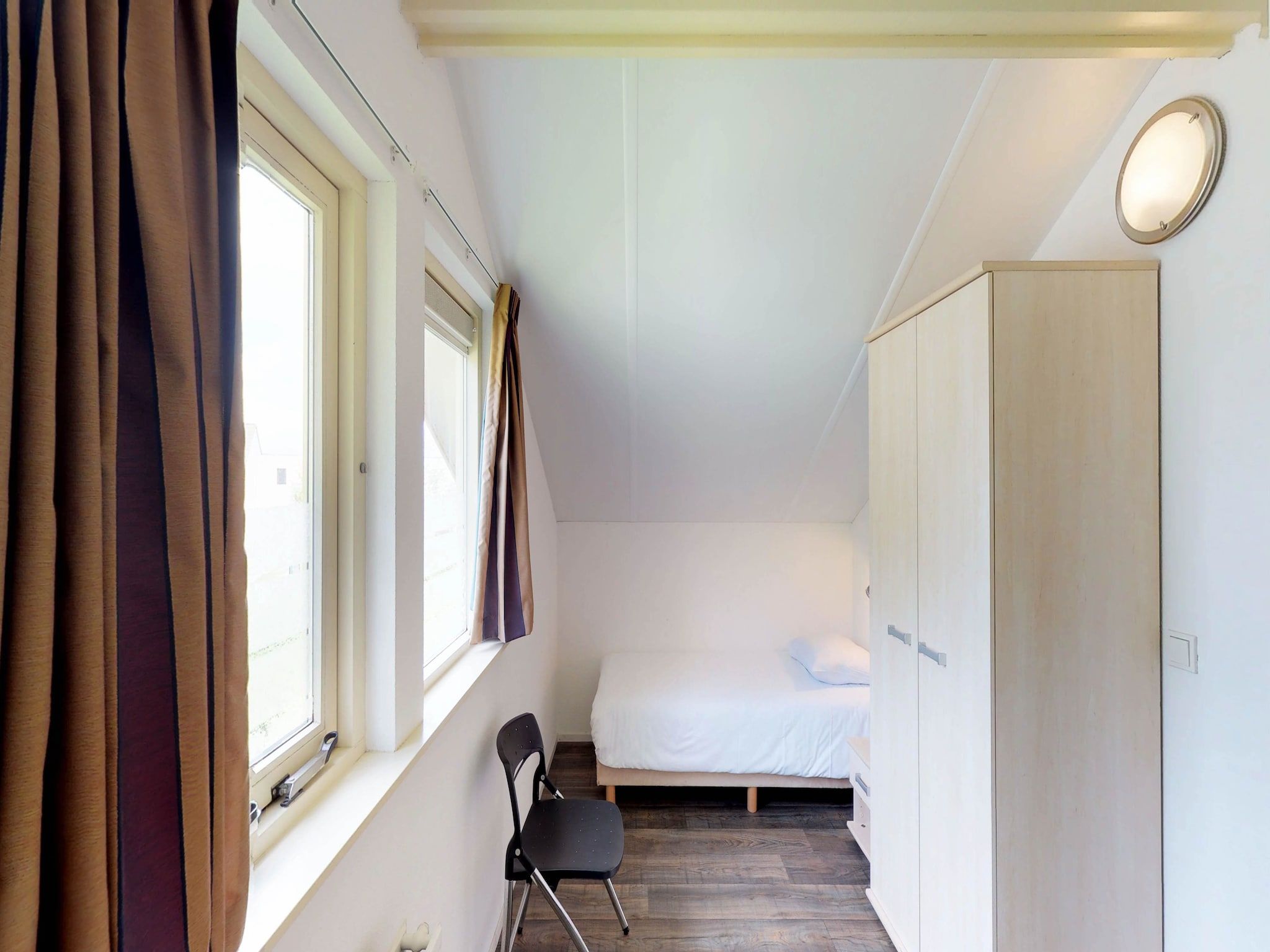 Een slaapkamer van Villapark de Paardekreek 5 in Kortgene