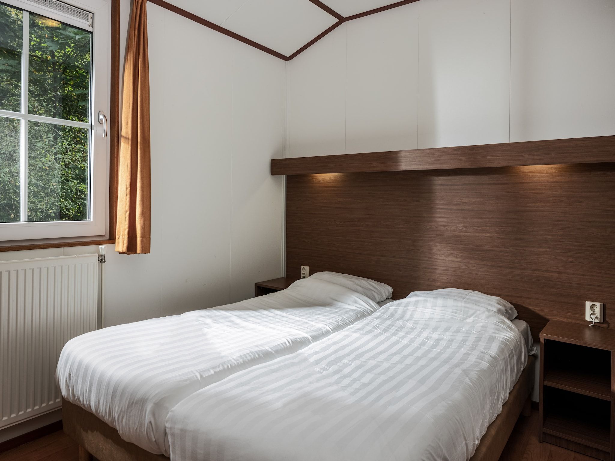 Een slaapkamer van Bospark Lunsbergen 5 in Borger