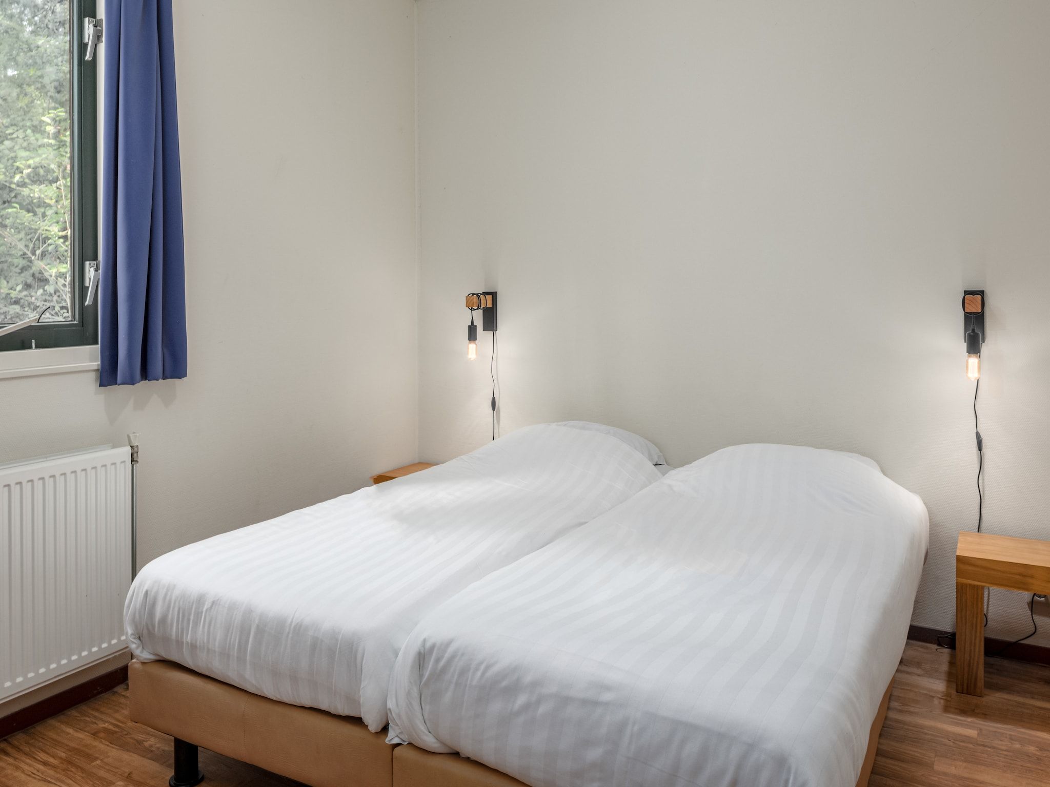 Een slaapkamer van Bospark Lunsbergen 7 in Borger