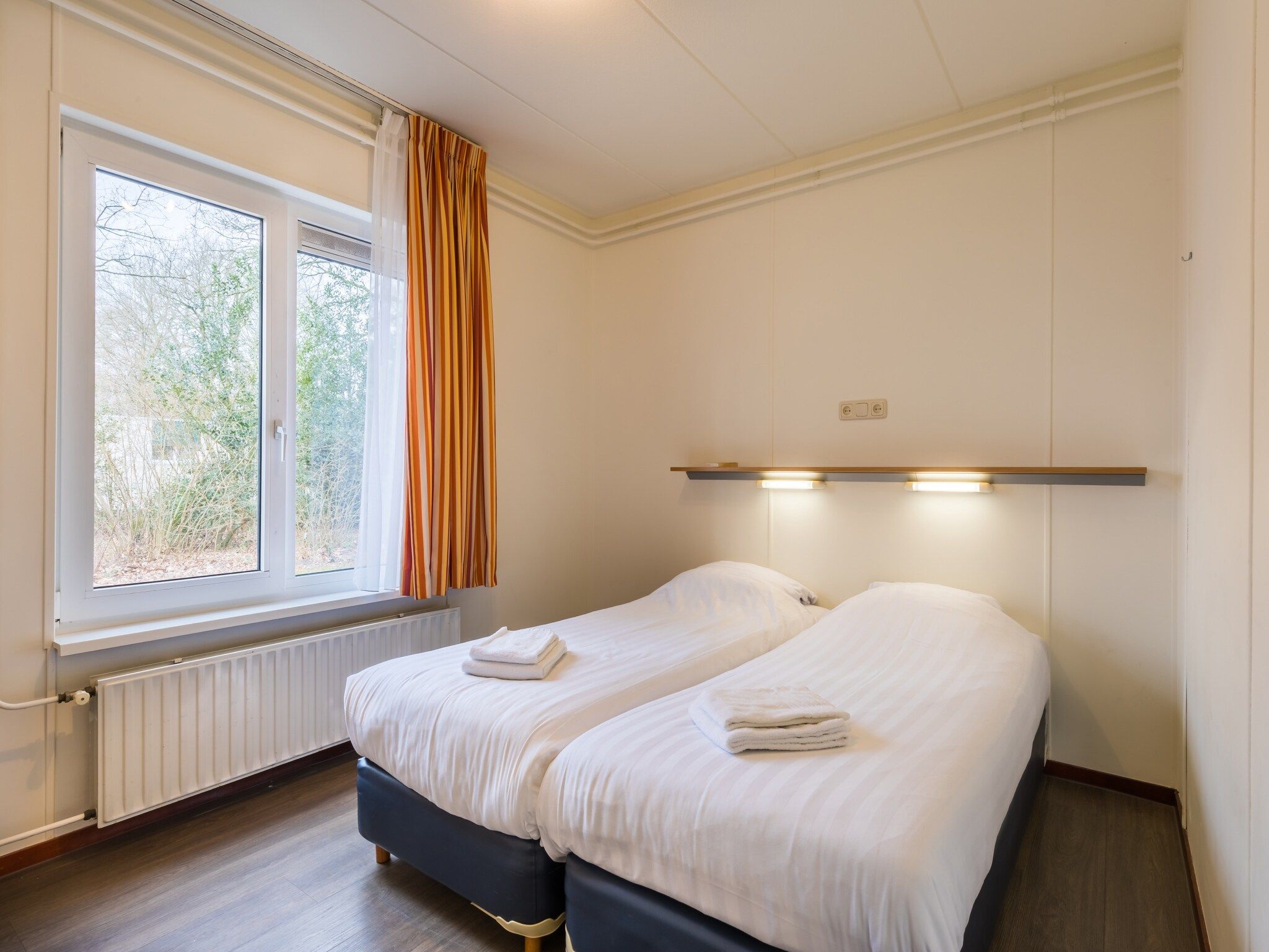 Een slaapkamer van Vakantiepark Hunzedal 4 in Borger