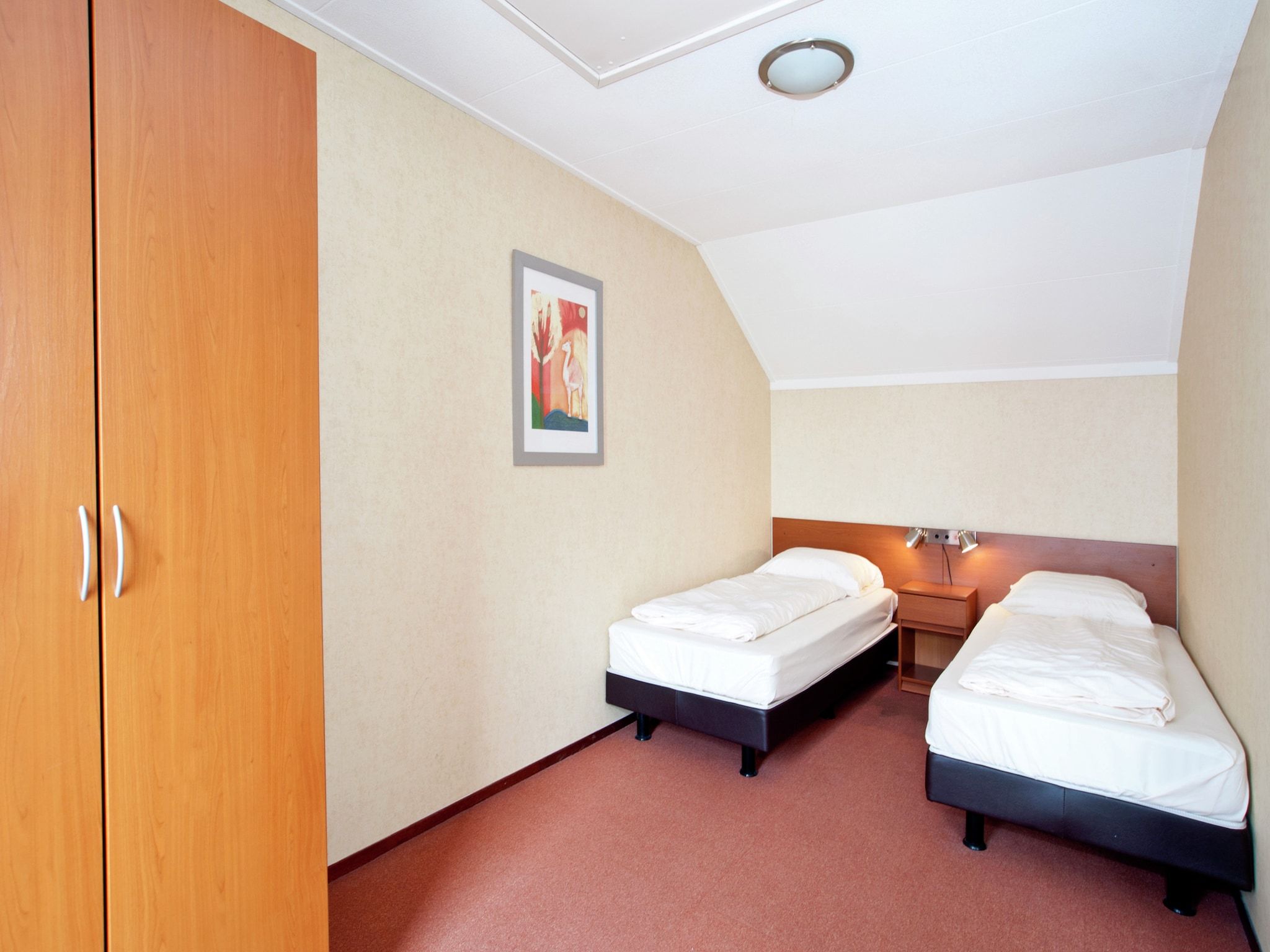 Een slaapkamer van Tuinvilla 2-4 persoons in Heel