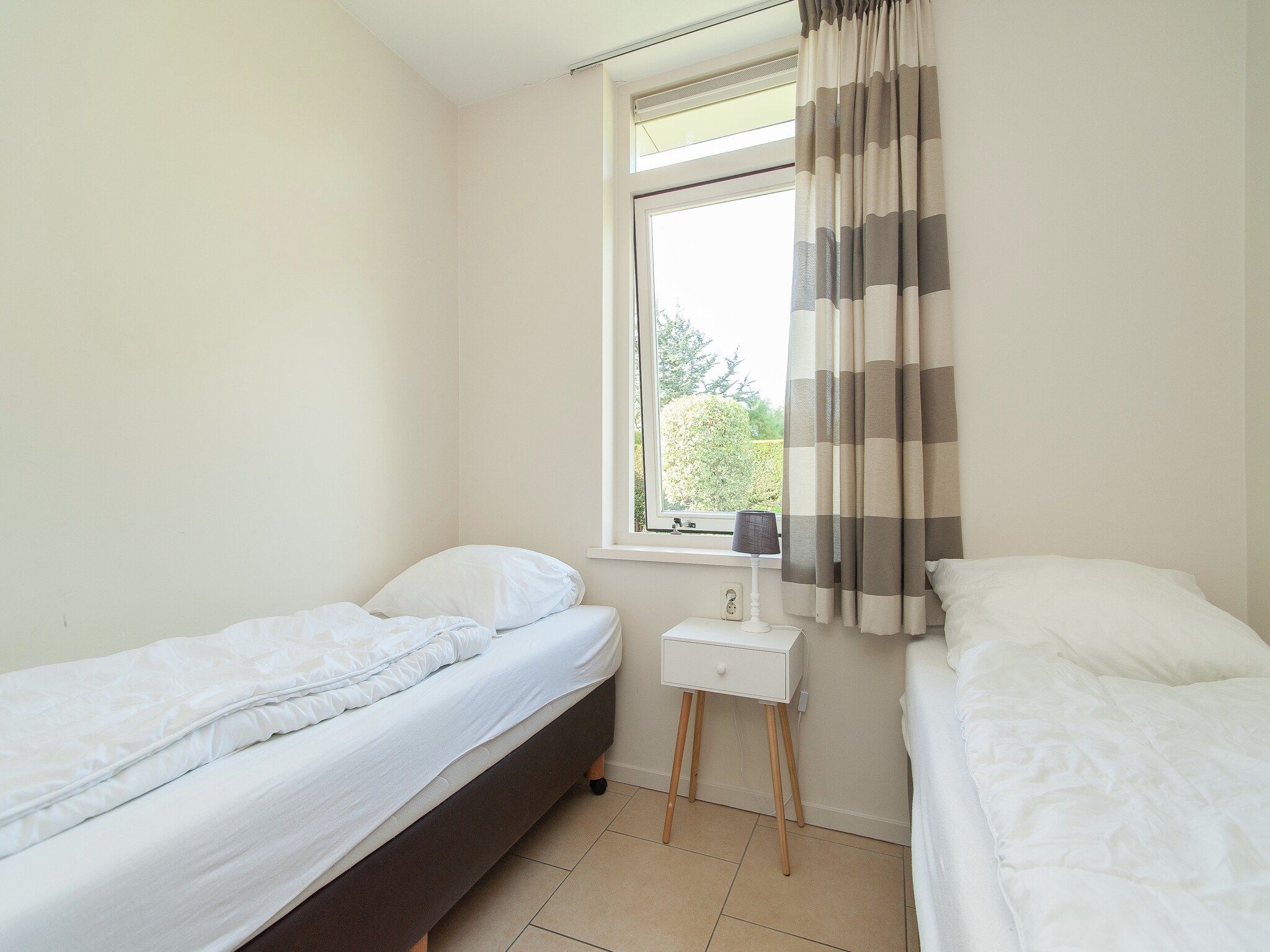 Een slaapkamer van Bungalowpark de Gouden Spar 2 in Noordwijk