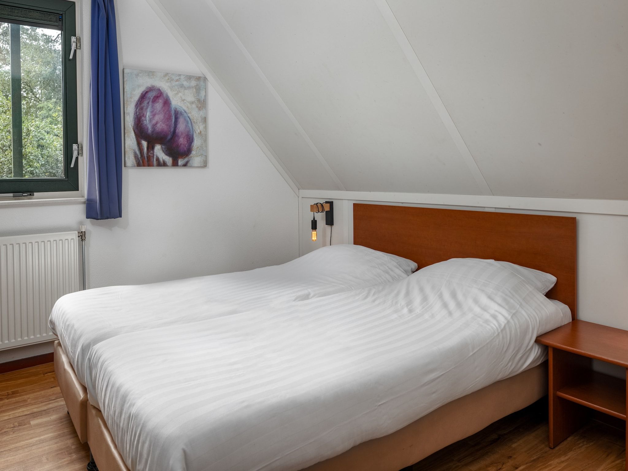 Een slaapkamer van Bospark Lunsbergen 2 in Borger