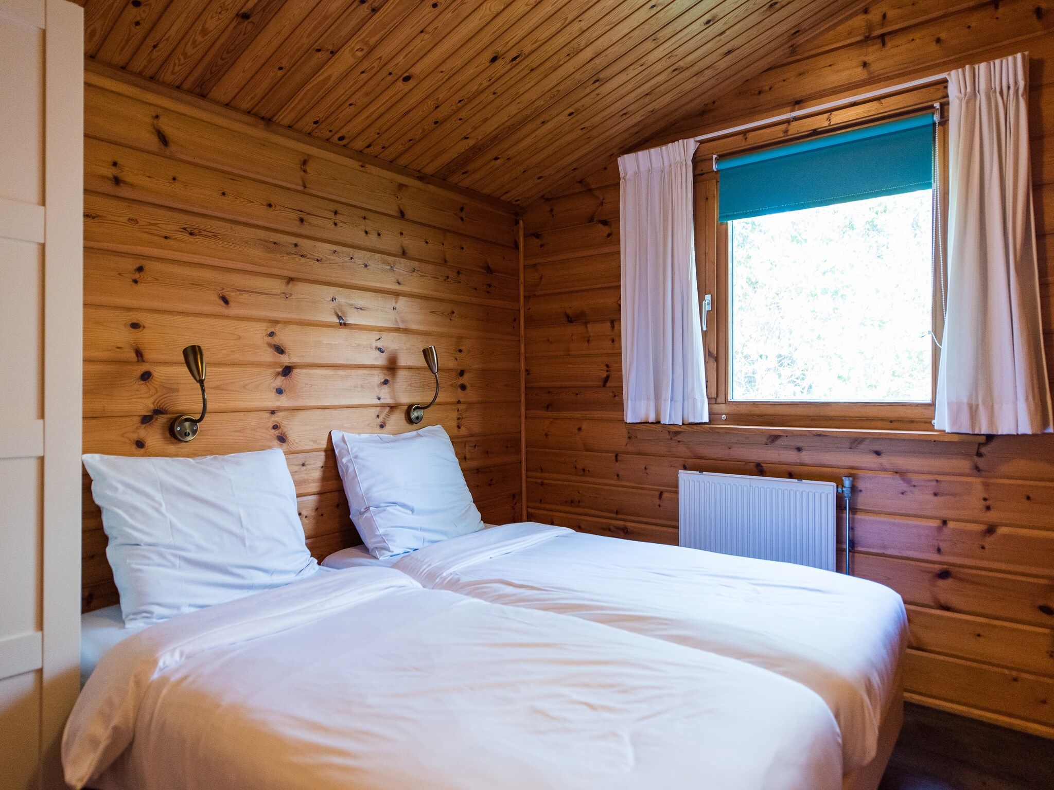 Een slaapkamer van Vakantiepark Boomhiemke 10 in Hollum