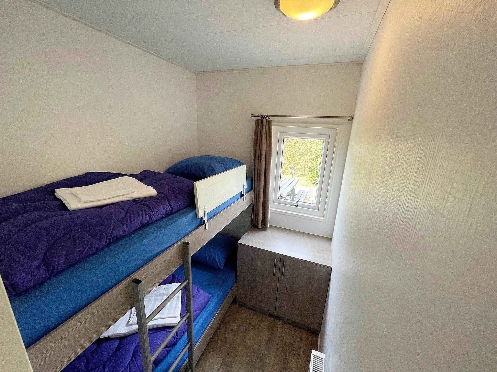 Een slaapkamer van Vakantiepark de Tabaksschuur 2 in Elst