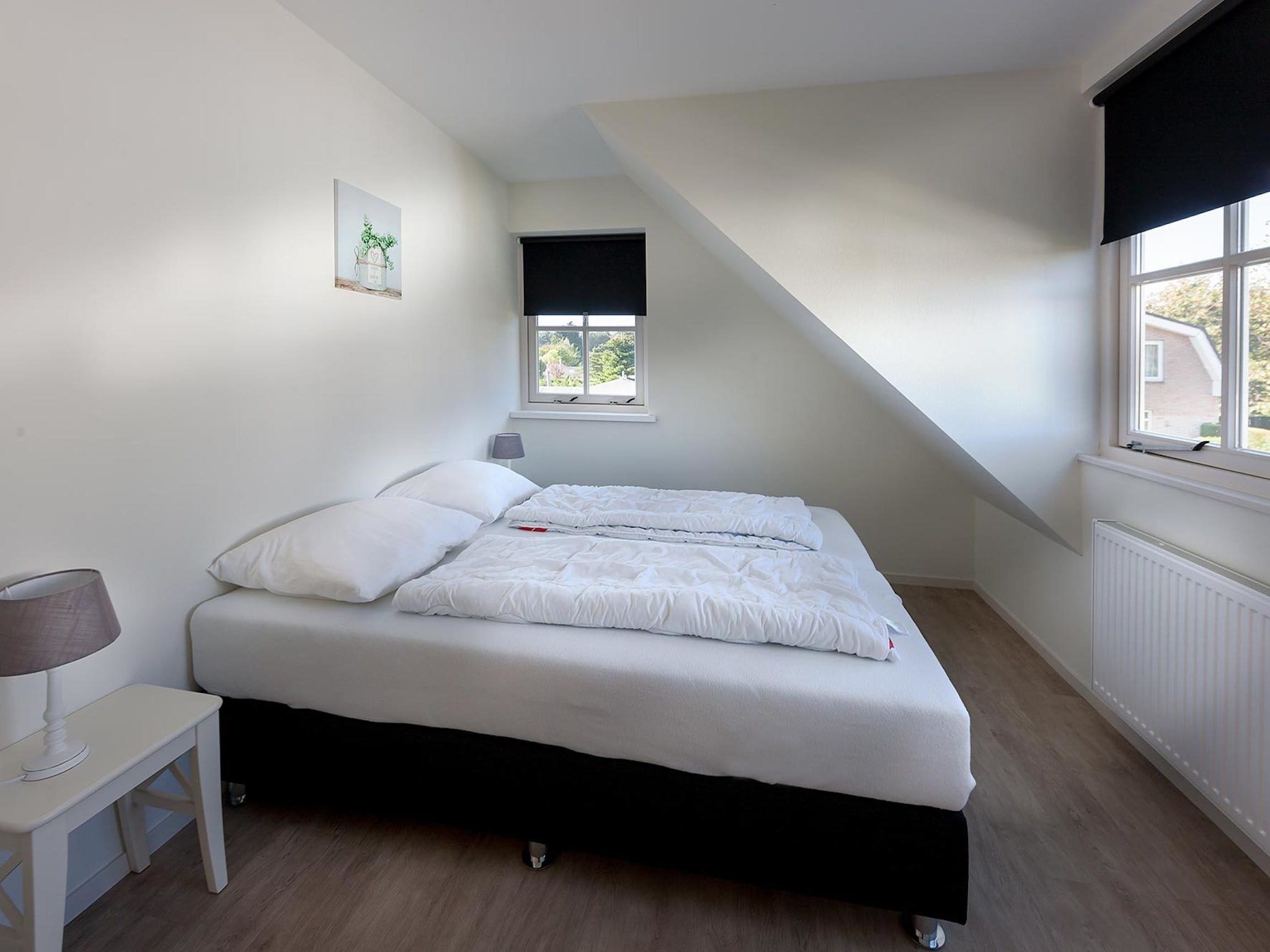 Een slaapkamer van Bungalowpark de Gouden Spar 5 in Noordwijk