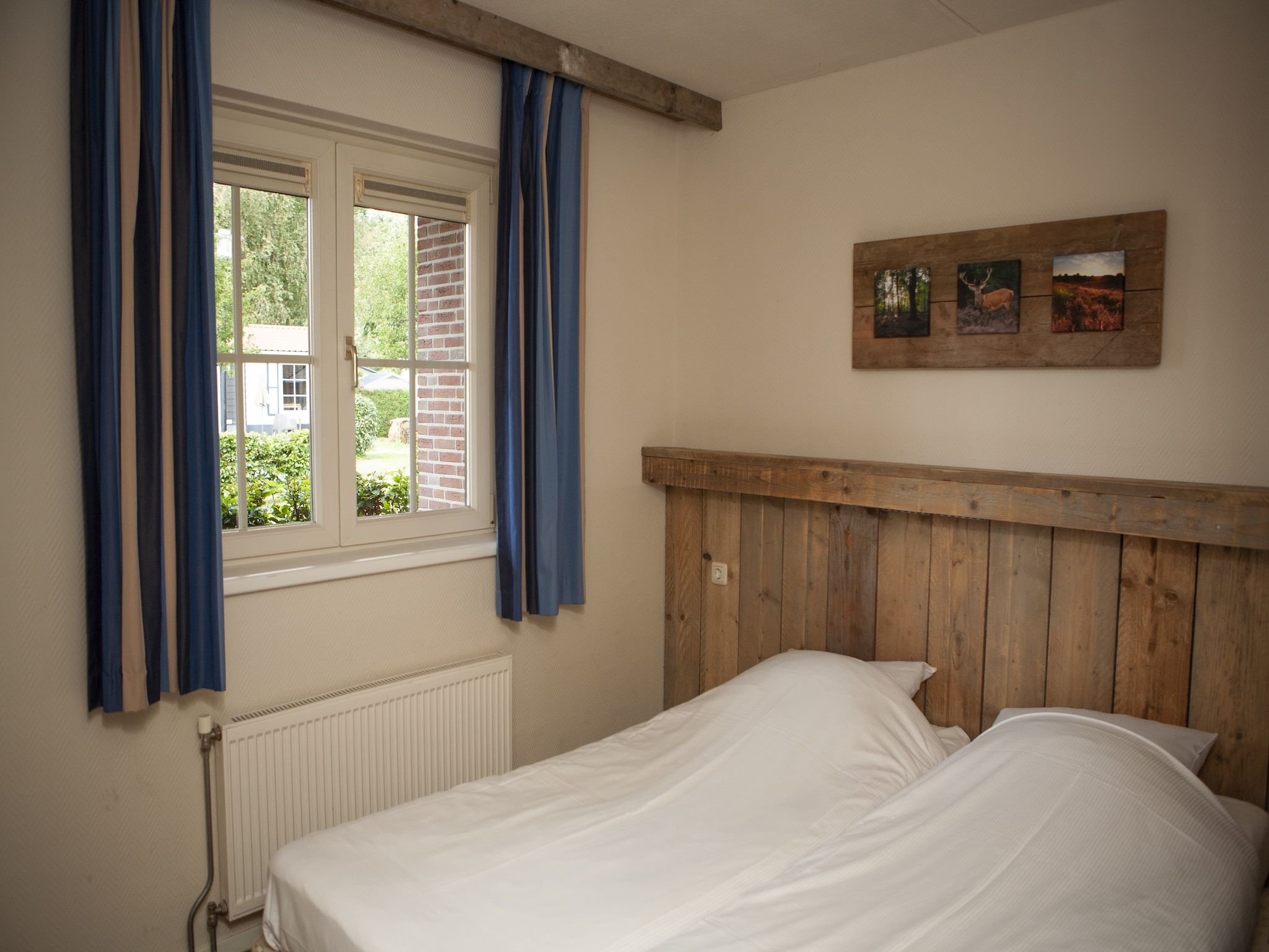 Een slaapkamer van Recreatiepark de Boshoek 11 in Voorthuizen