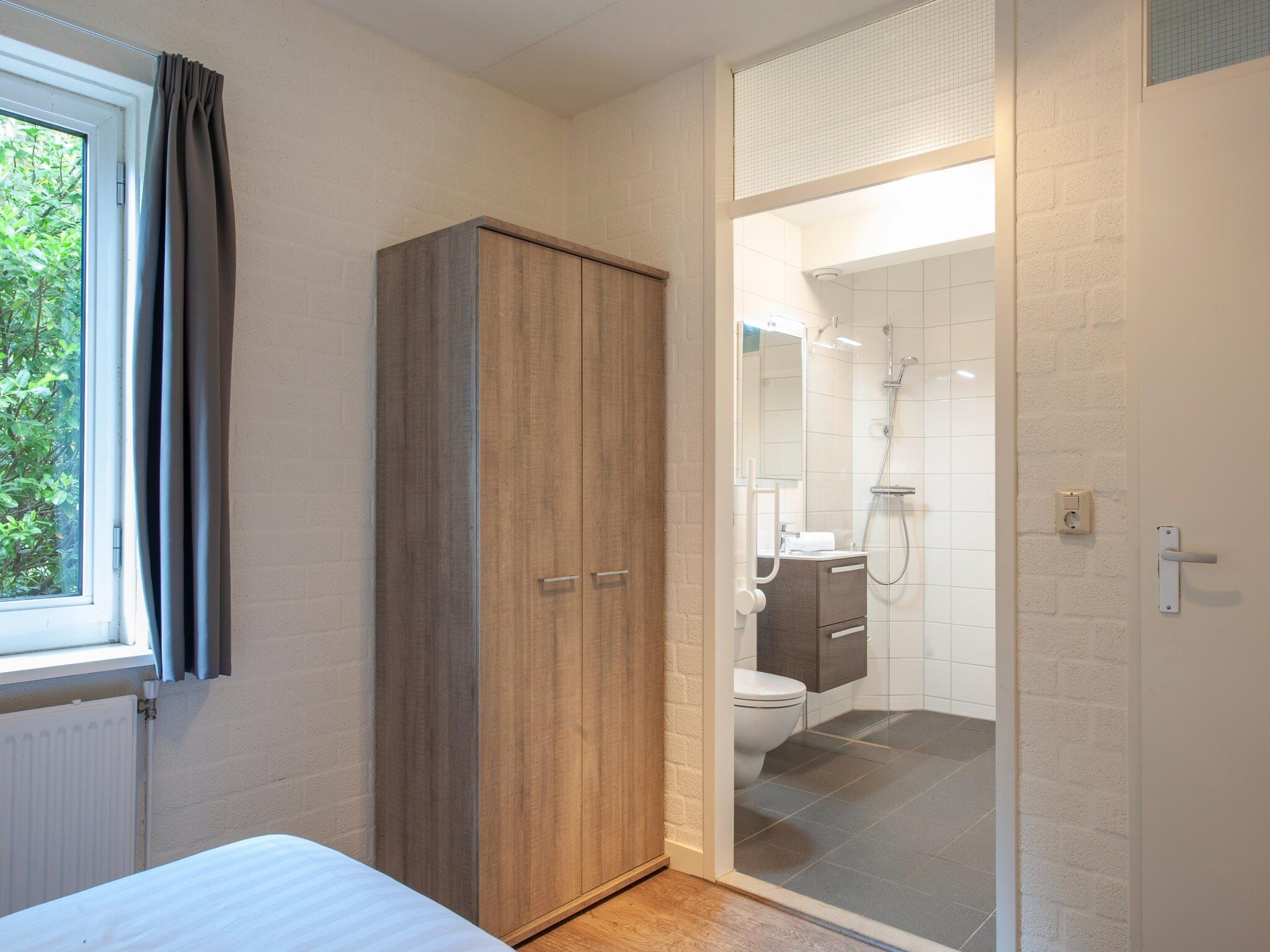 Een slaapkamer van Vakantiepark de Katjeskelder 10 in Oosterhout