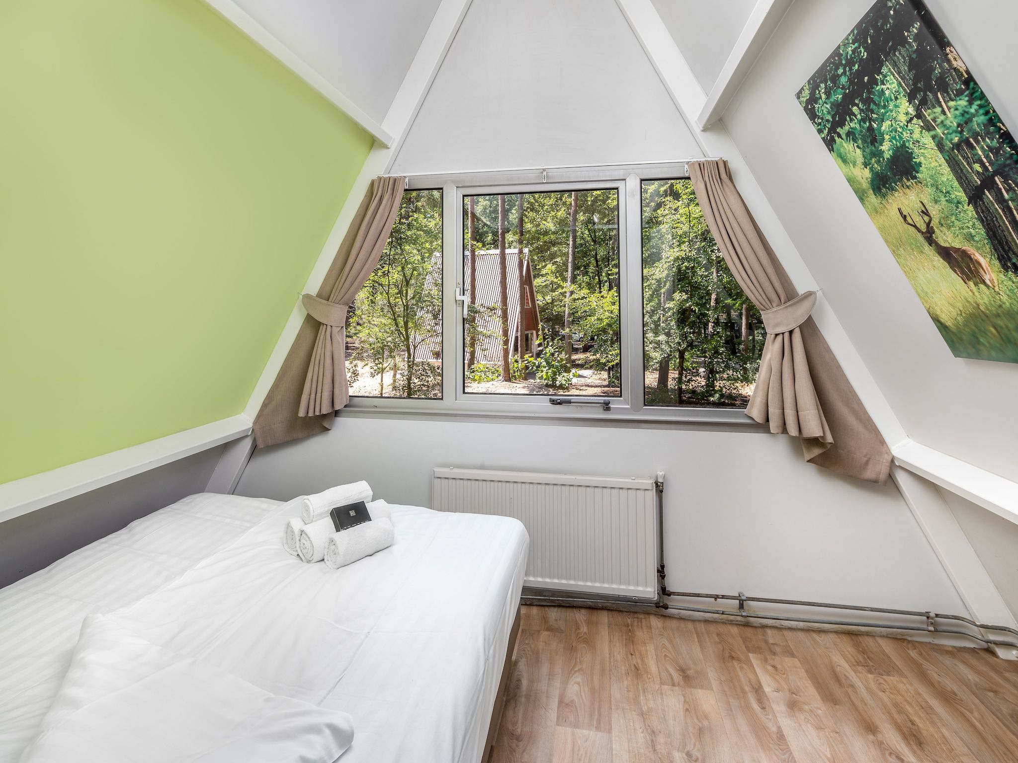 Een slaapkamer van Bospark 't Wolfsven 7 in Mierlo