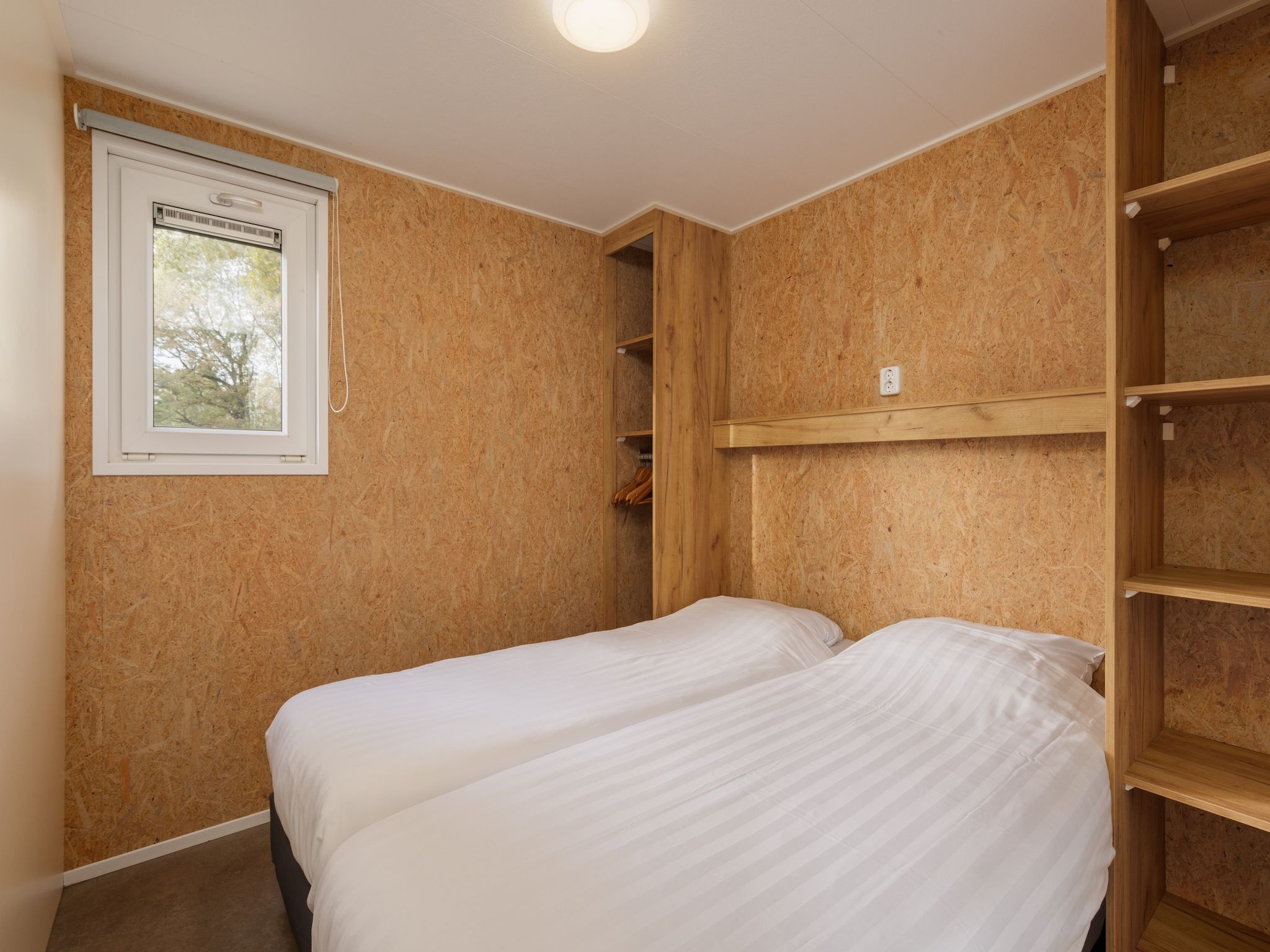 Een slaapkamer van Vakantiepark Hunzedal 9 in Borger