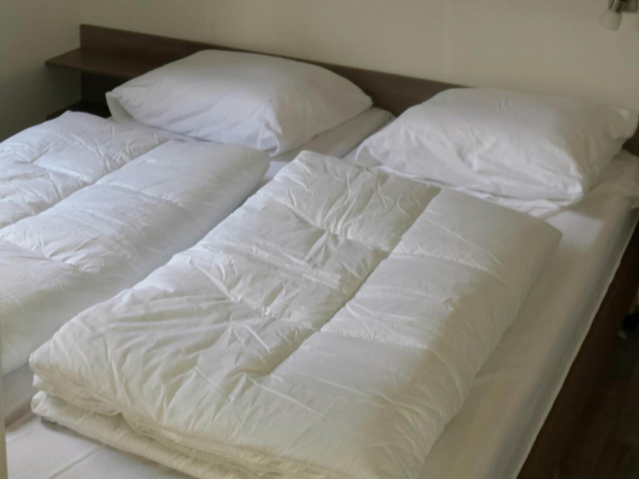 Een slaapkamer van Vakantiepark de Tabaksschuur 3 in Elst