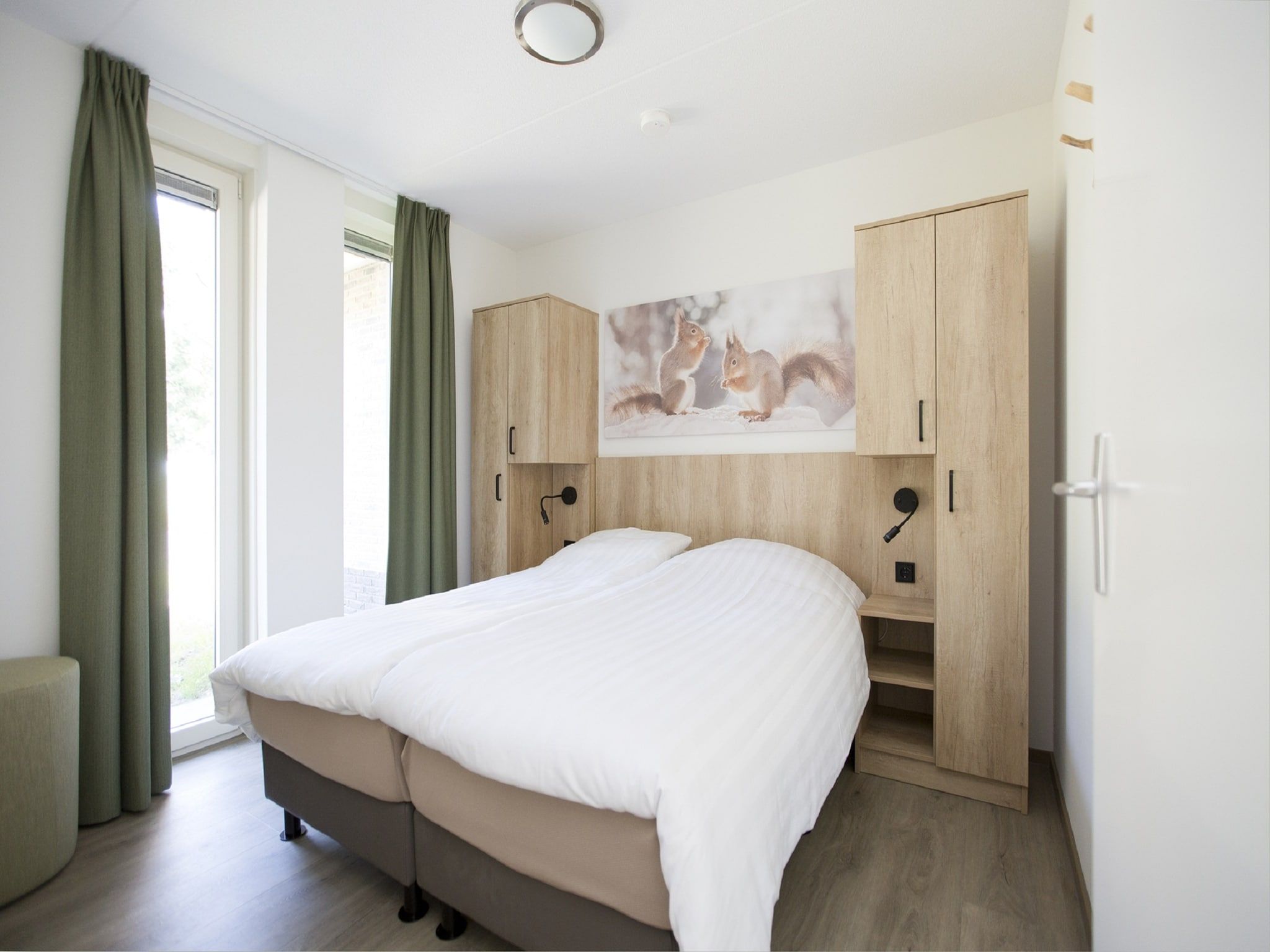 Een slaapkamer van Landgoed De IJsvogel 8 in Voorthuizen