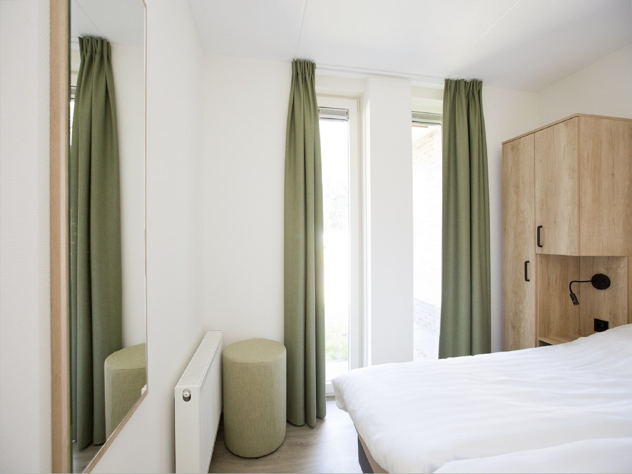 Een slaapkamer van Landgoed De IJsvogel 8 in Voorthuizen