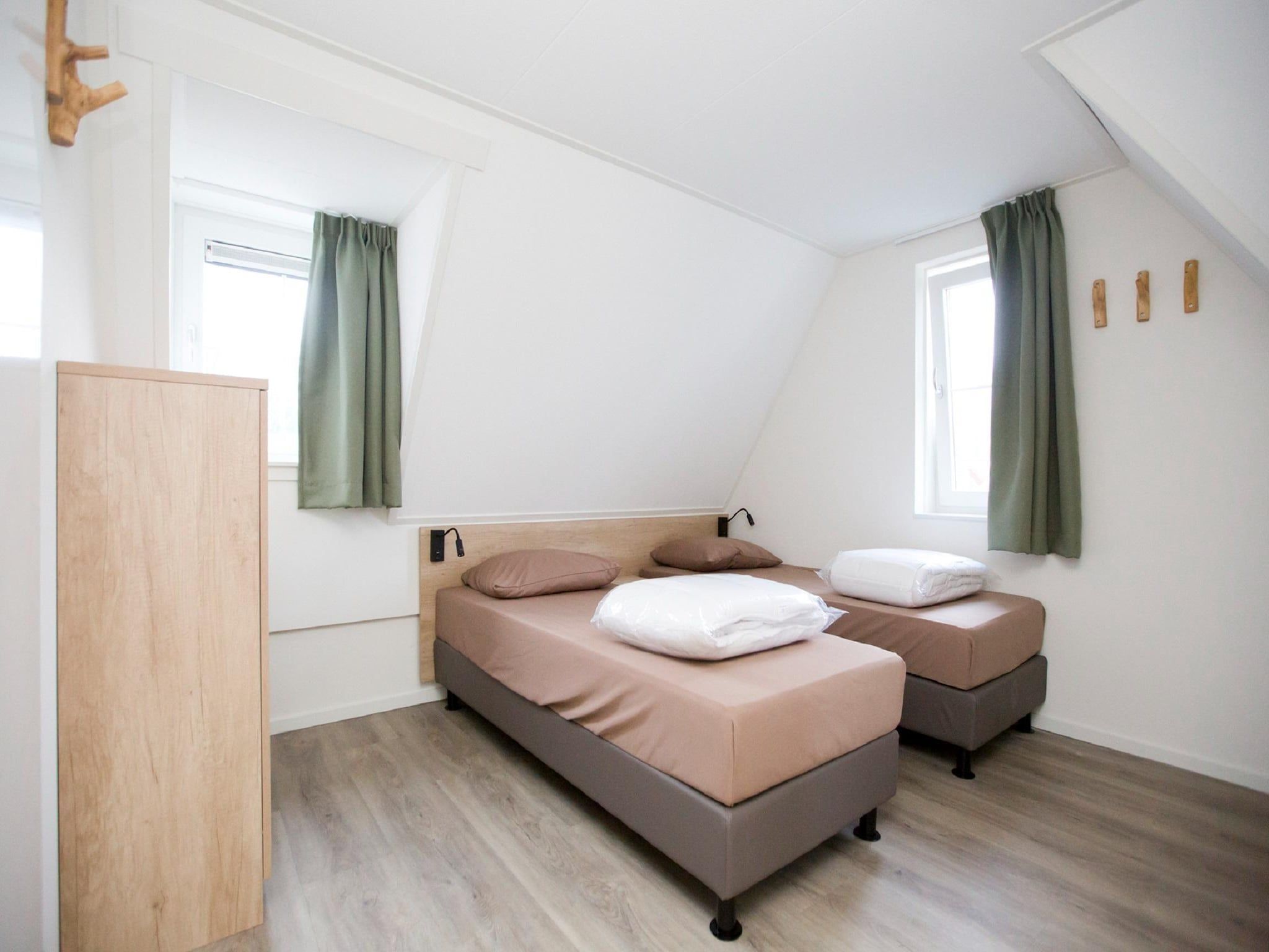 Een slaapkamer van Landgoed De IJsvogel 9 in Voorthuizen