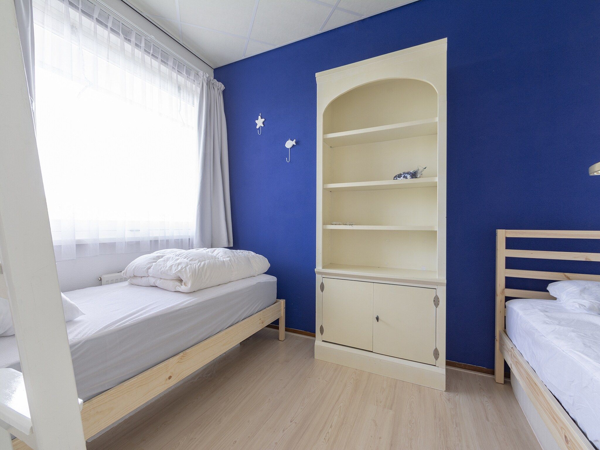 Een slaapkamer van Strandslag 115 in Julianadorp aan Zee