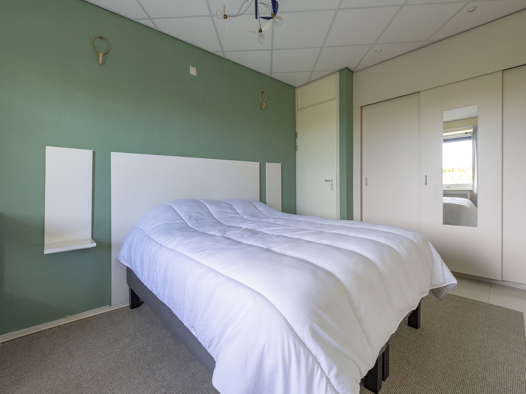 Een slaapkamer van Strandslag 115 in Julianadorp aan Zee